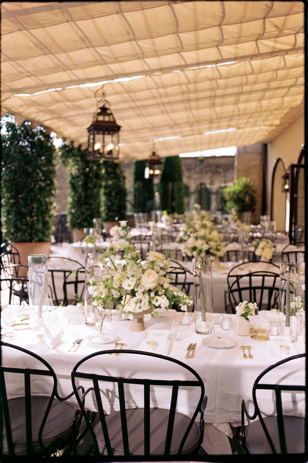 Reception tablescape with white florals and lanterns at Airelles Gordes La Bastide, Provence