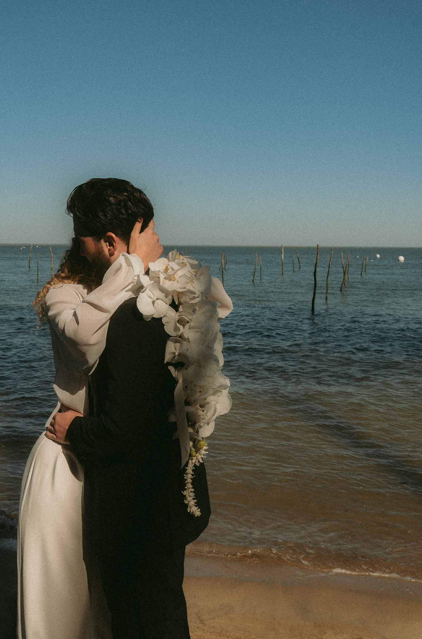 Bride and groom portrait by the sea