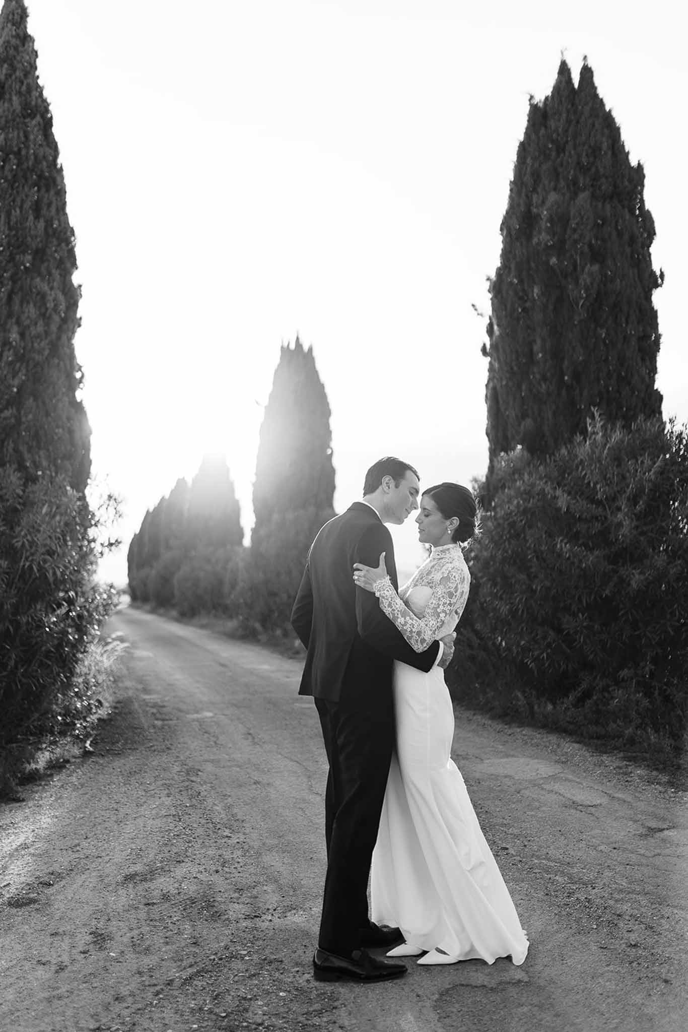 Black and white photo of bride and groom embracing
