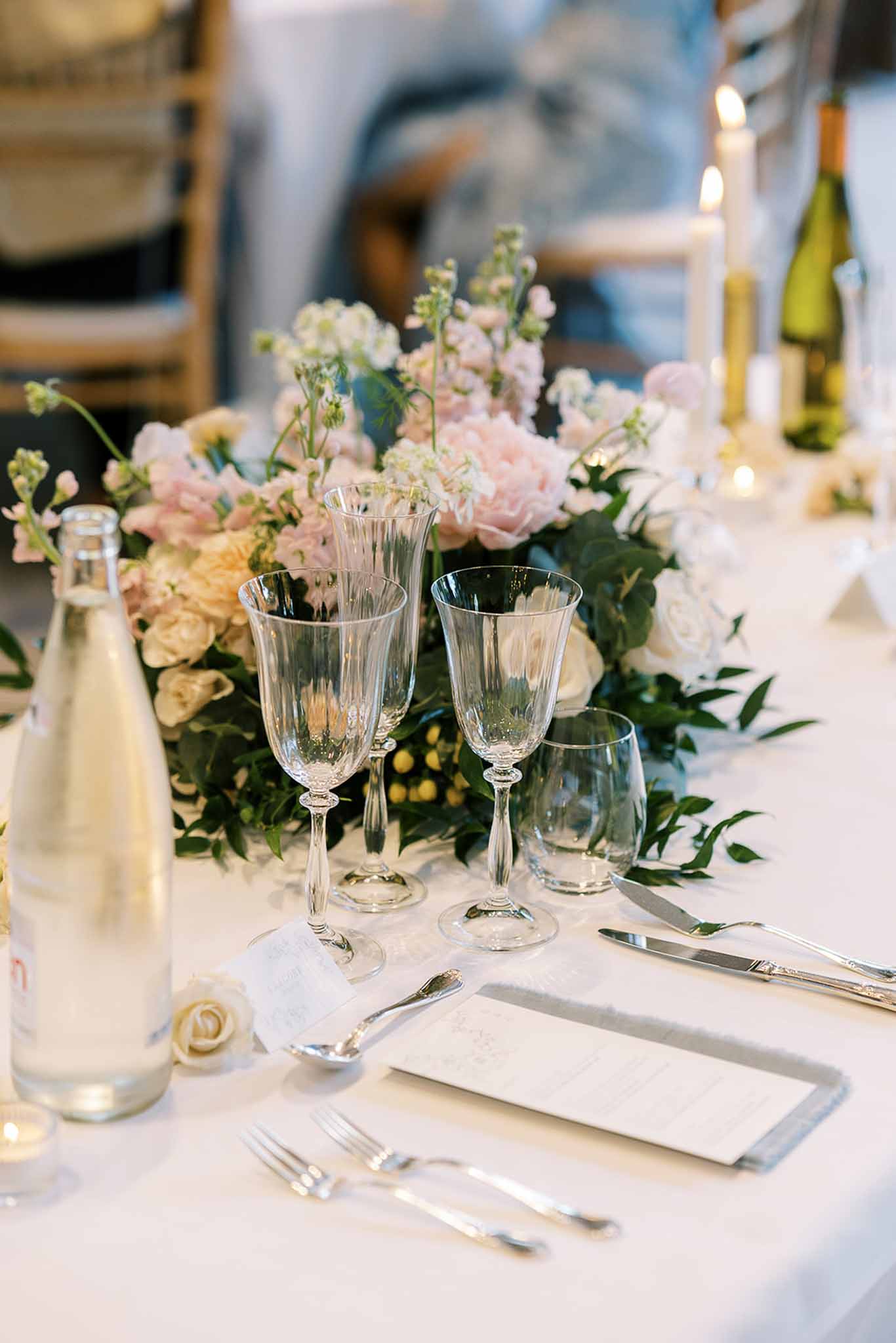 Wedding reception table setting in a garden with white roses
