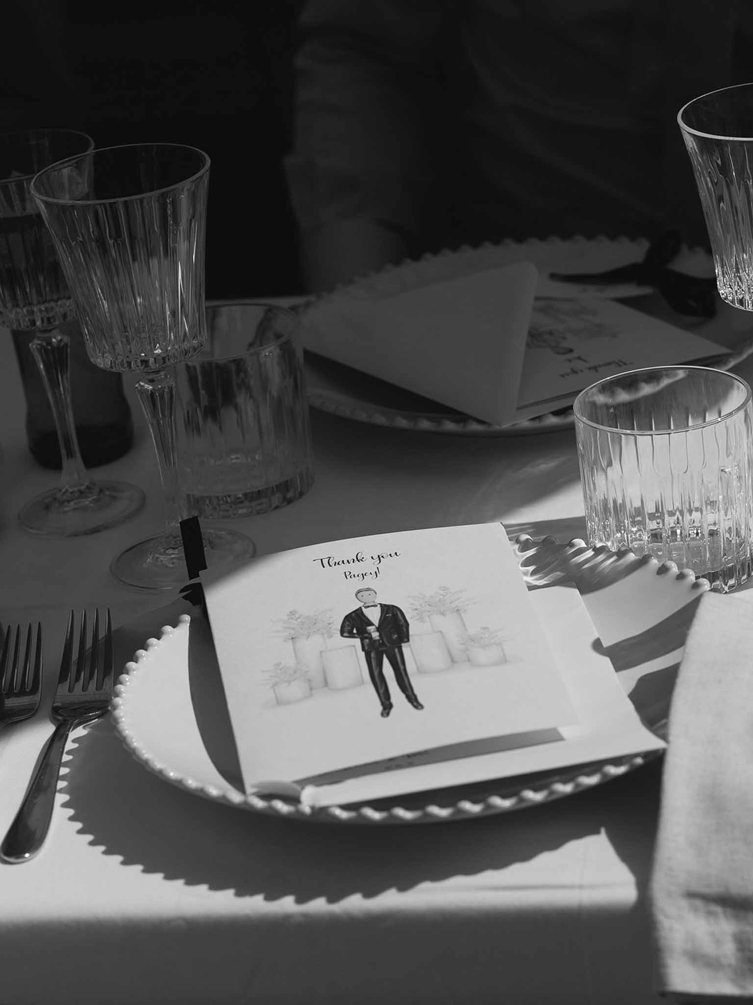 Black and white photo of wedding reception table setting