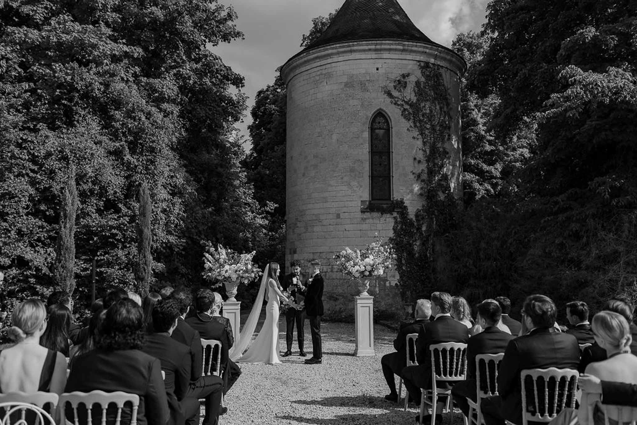 Black and white photo of wedding ceremony setup with white roses
