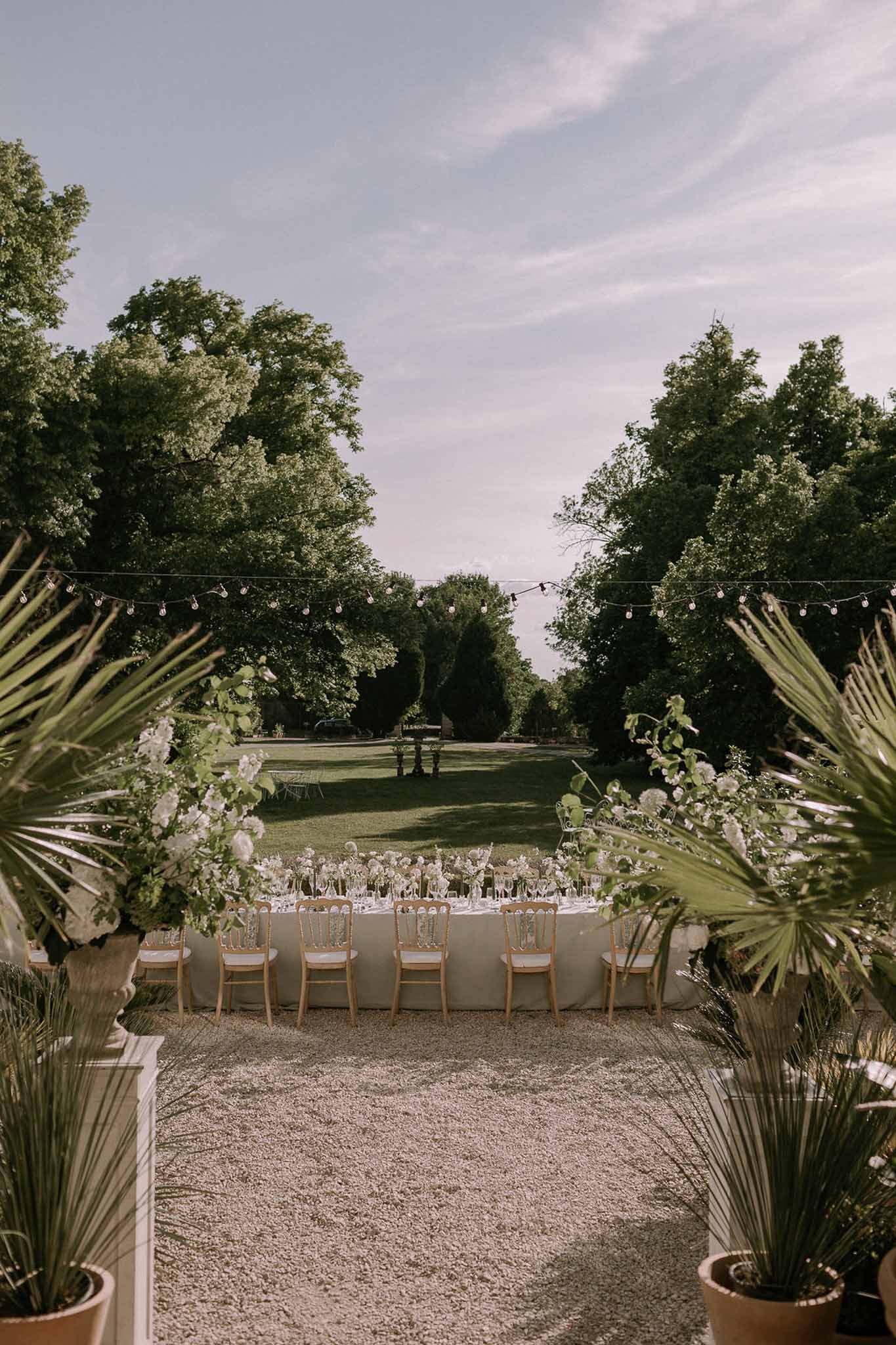 Wedding reception table setting in a garden with white roses