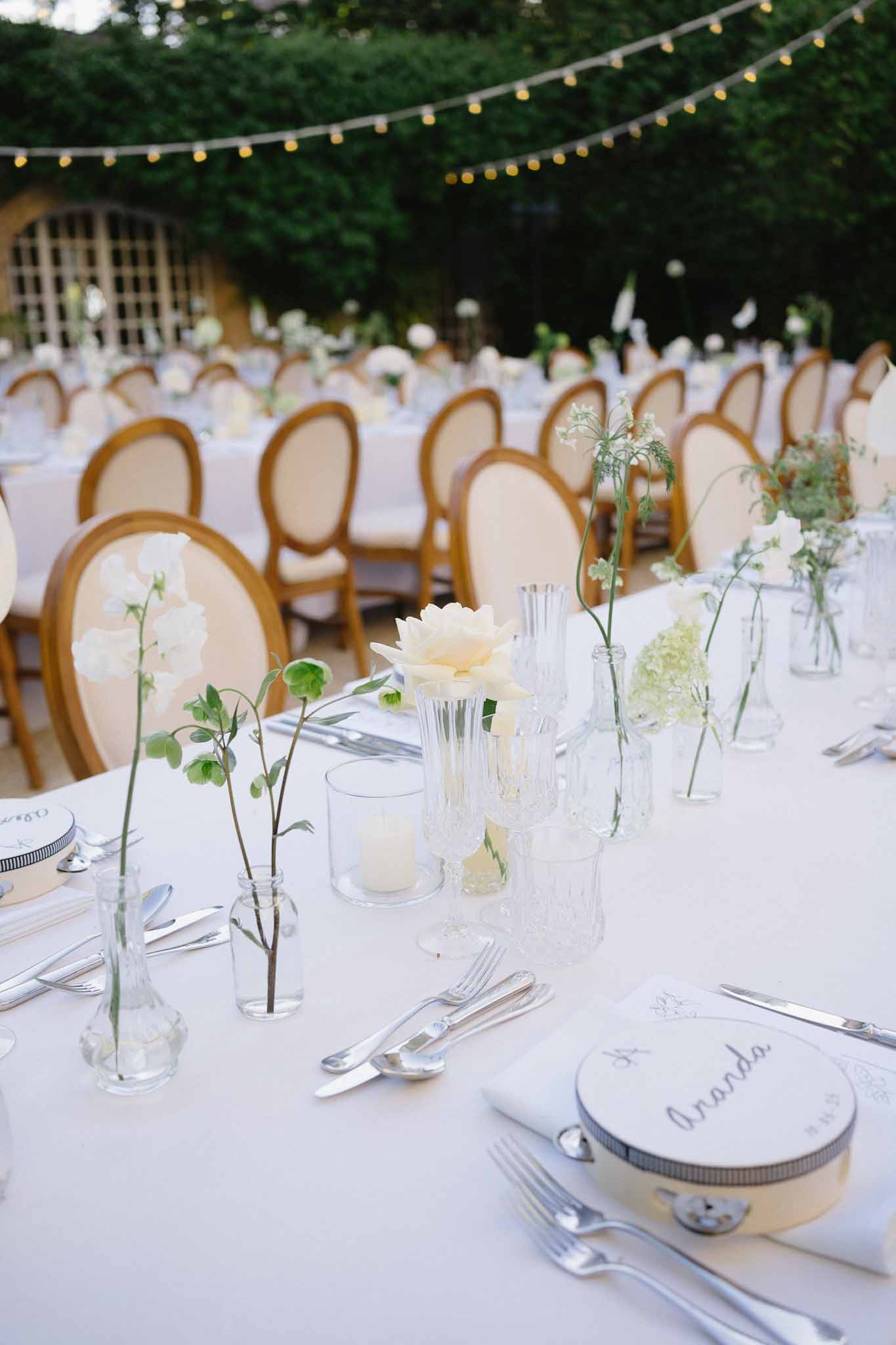 Wedding reception table setting in a garden with hydrangeas