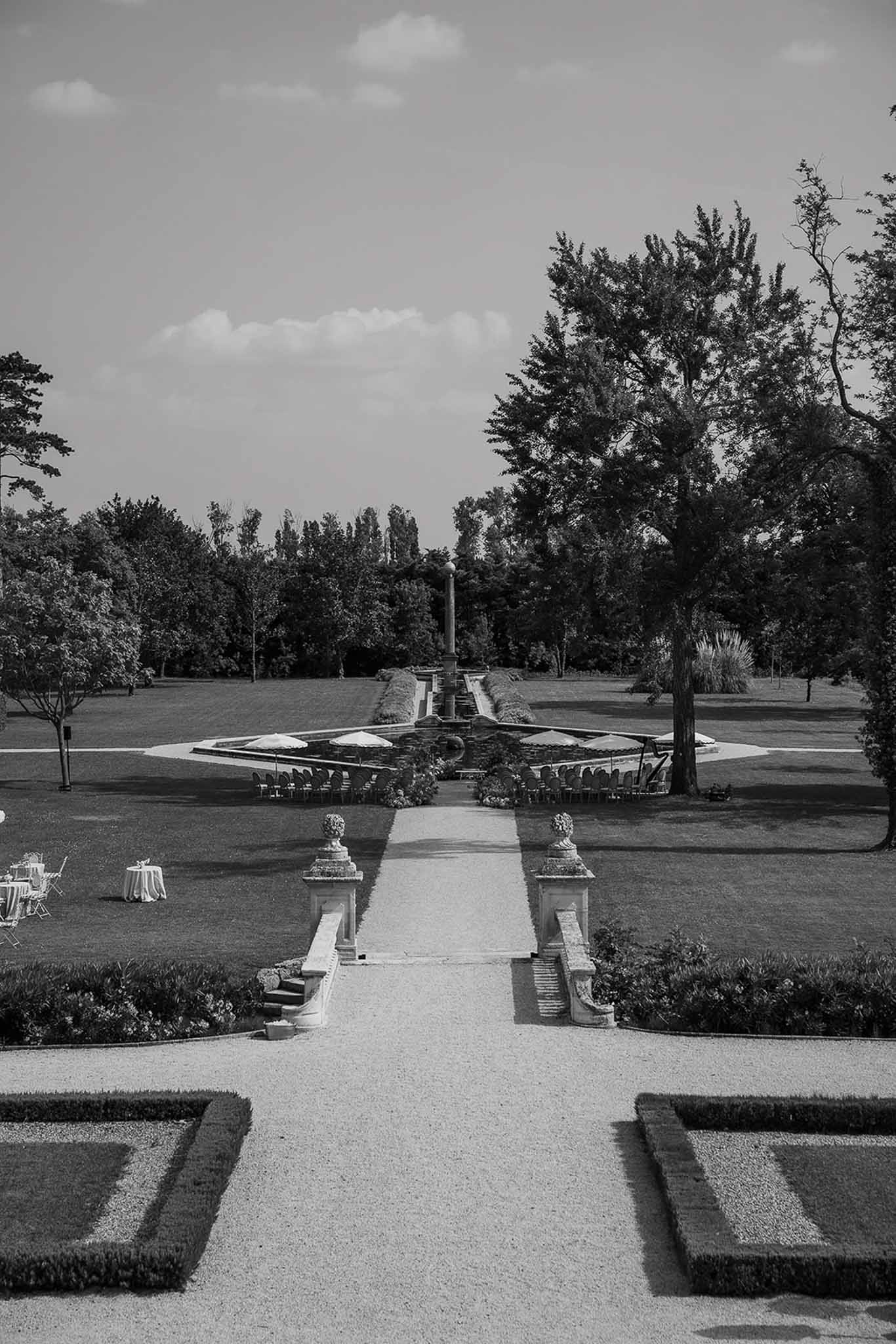 Black and white photo of wedding ceremony setup in a garden