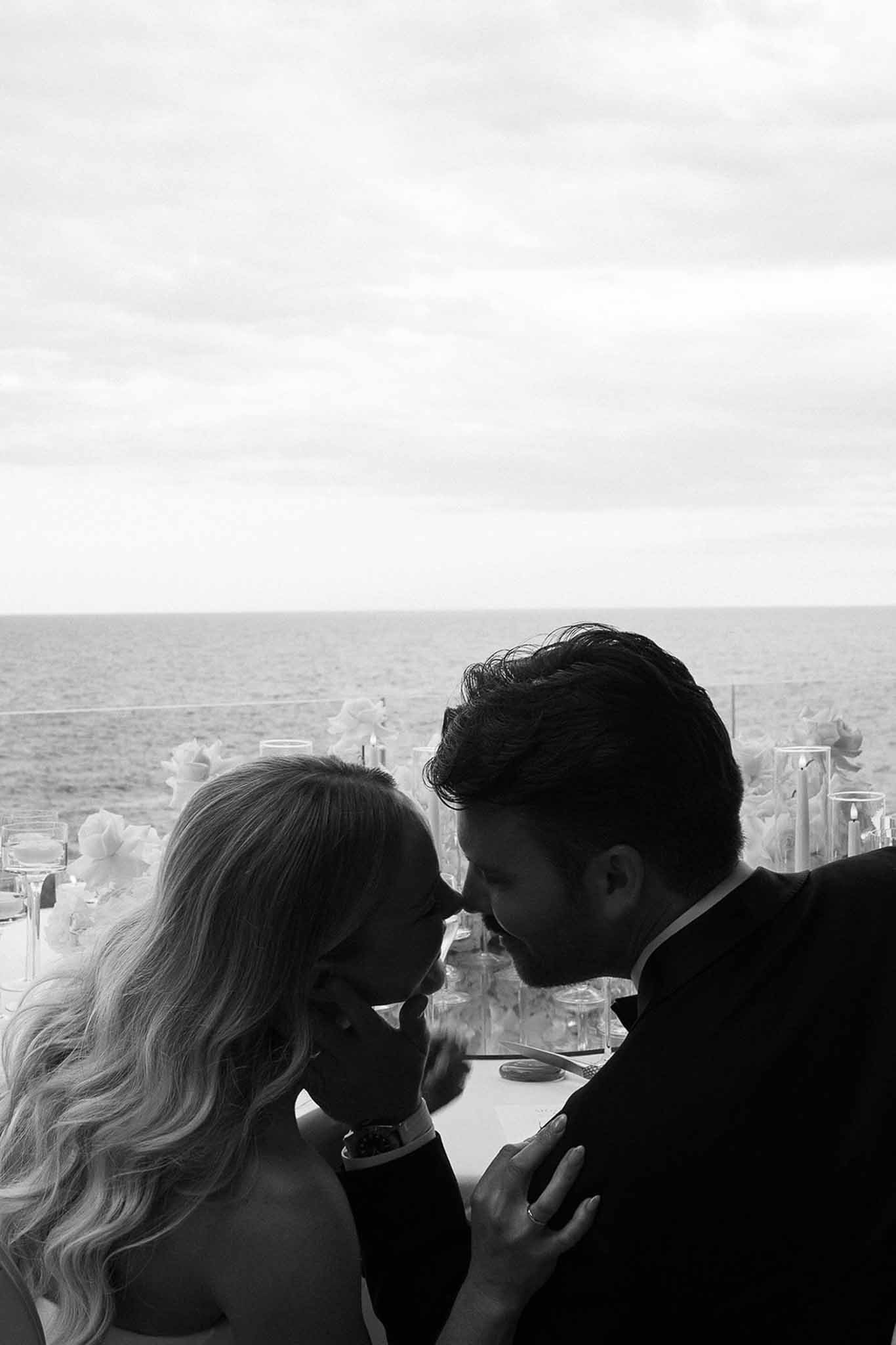 Black and white photo of wedding reception room in a garden with white roses