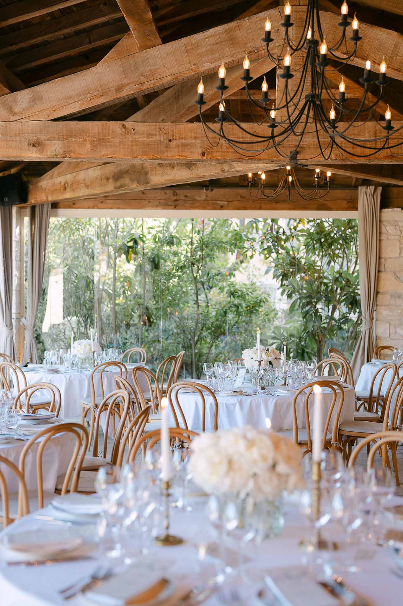 Wedding reception table setting in a garden with white roses