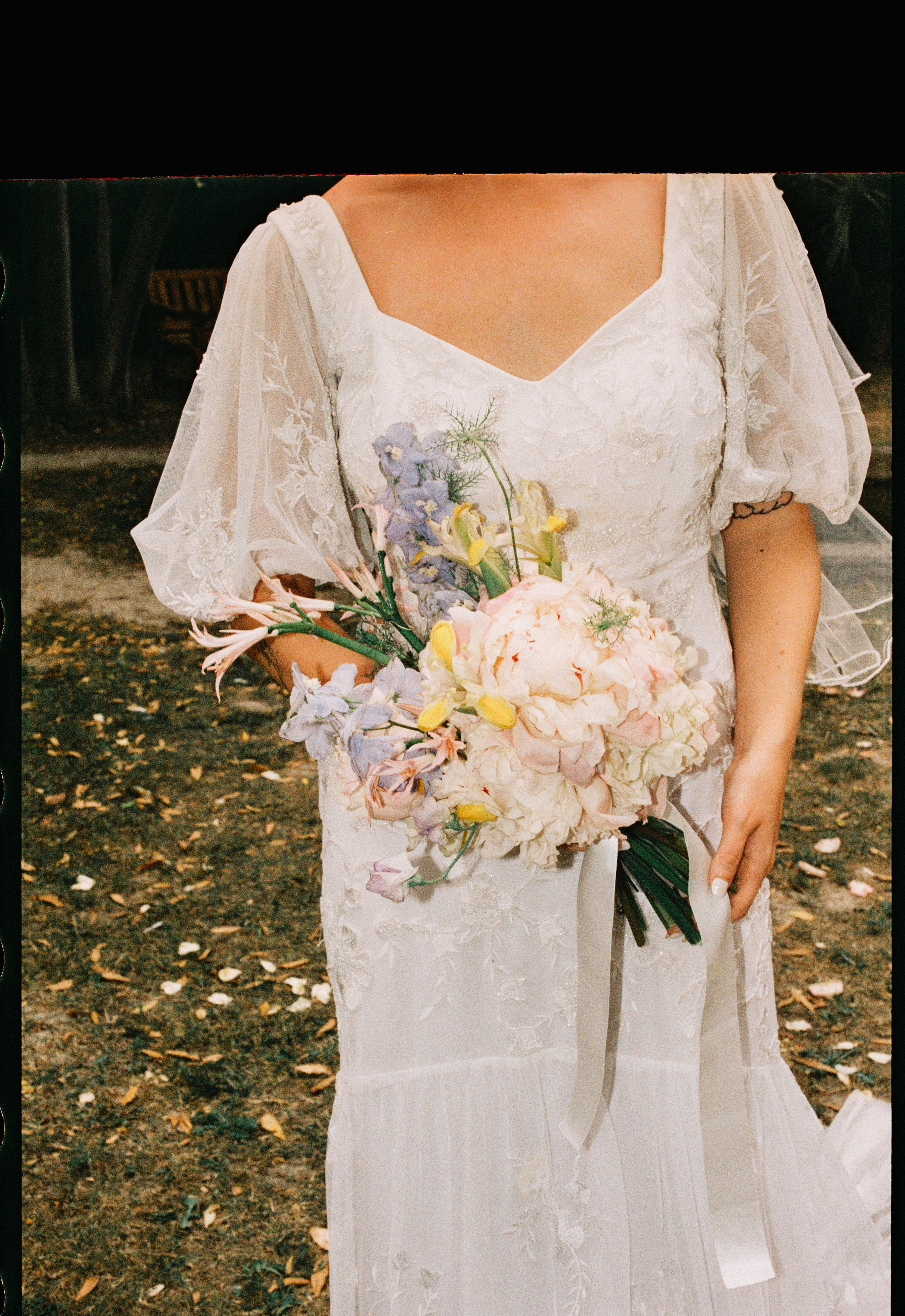 Close up of pastel bouquet and lace wedding dress at Chateau du Puits es Pratx, Ginestas