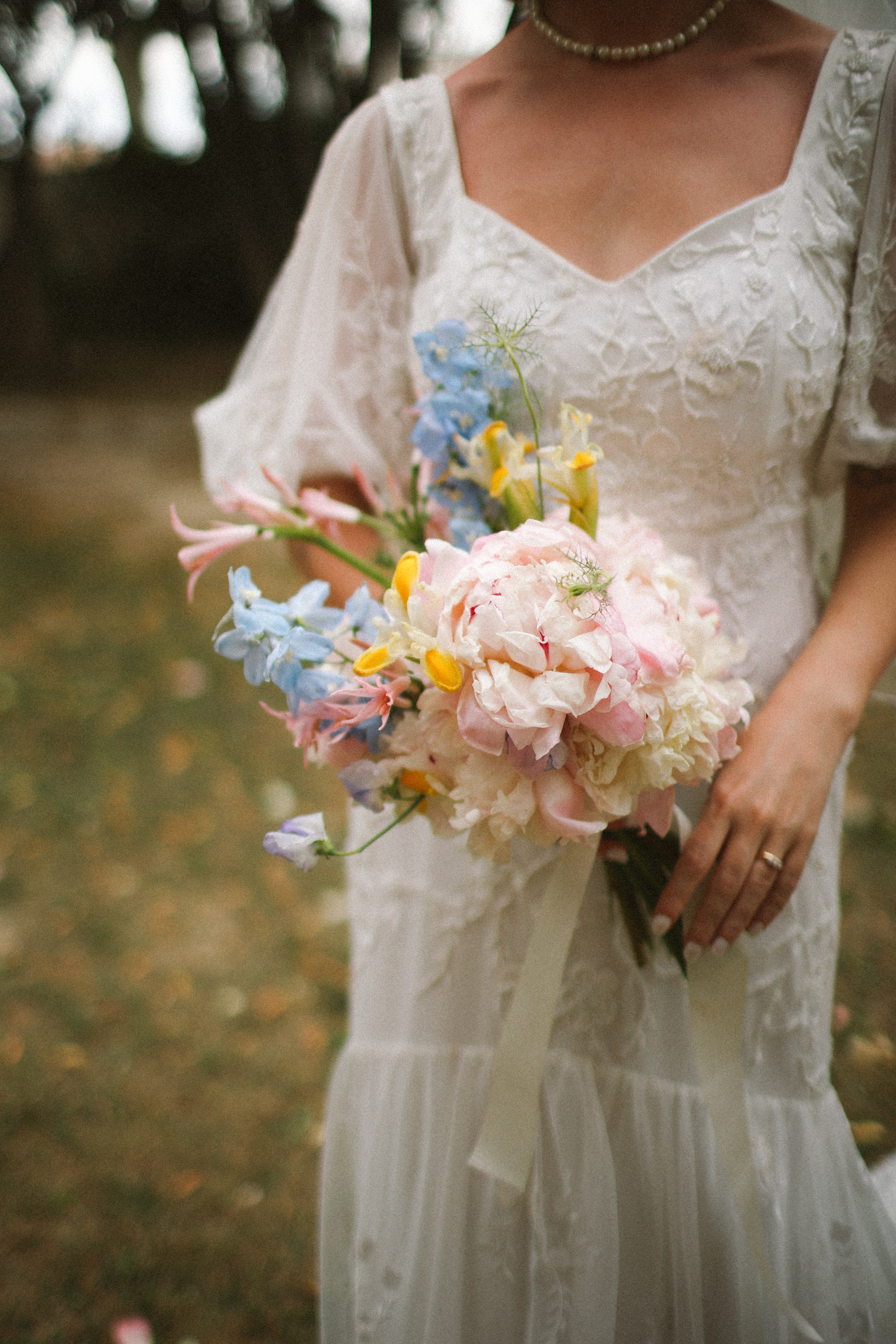 Pastel peony and delphinium bouquet with lace gown at Chateau du Puits es Pratx, Ginestas