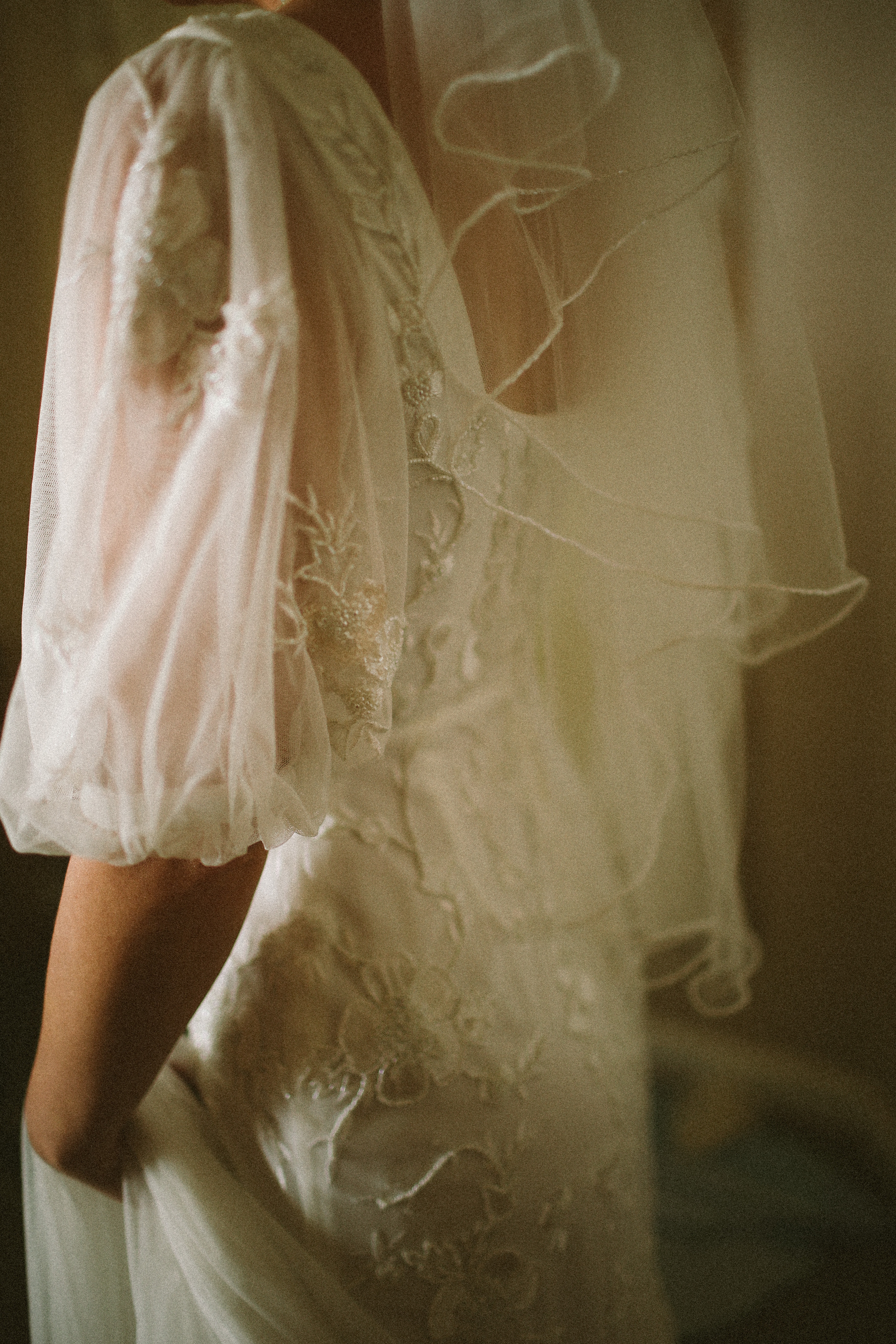 Close up of lace bodice puff sleeve and veil at Chateau du Puits es Pratx, Ginestas