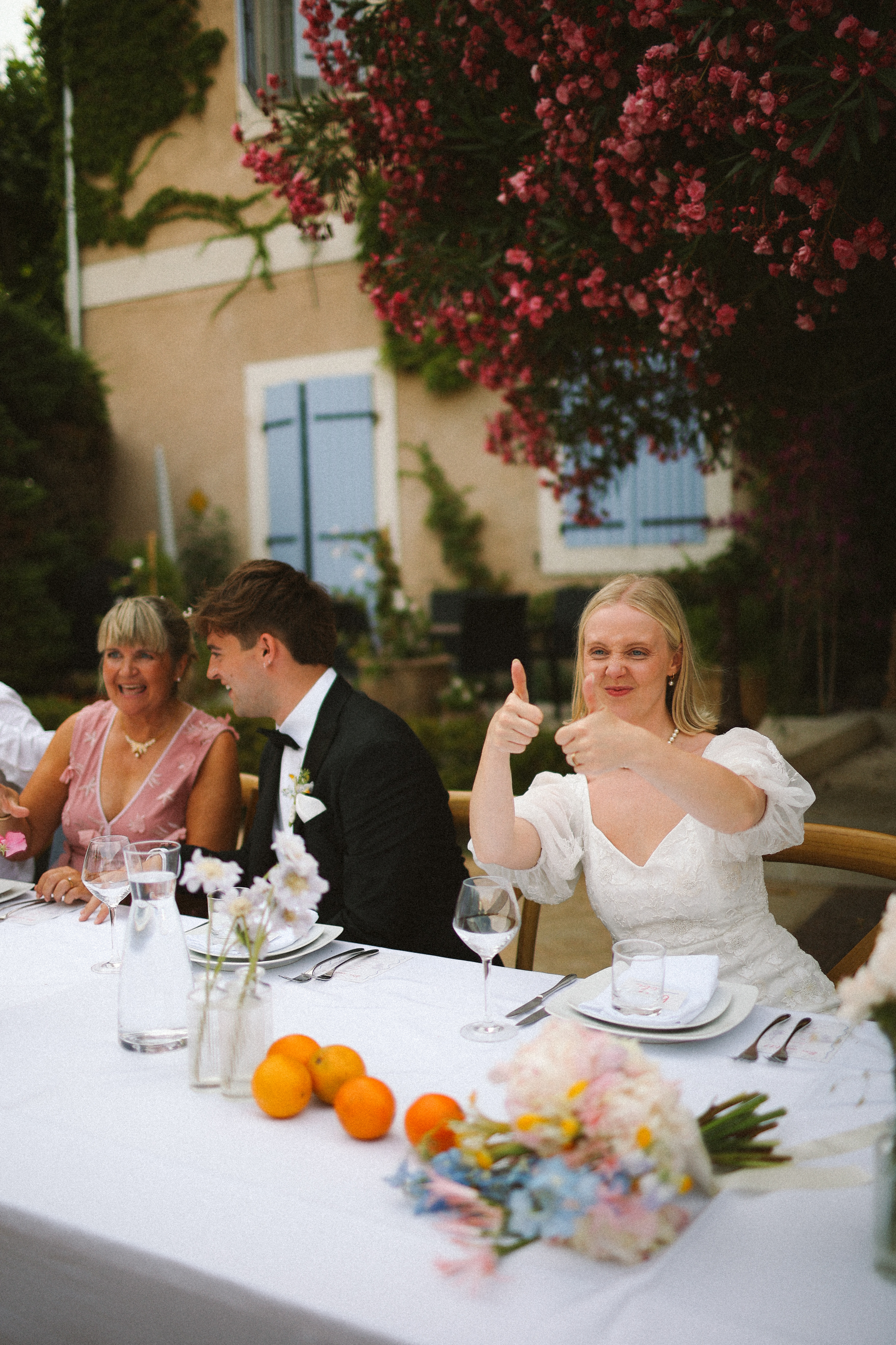 Bride giving thumbs up at top table at Chateau du Puits es Pratx, Ginestas