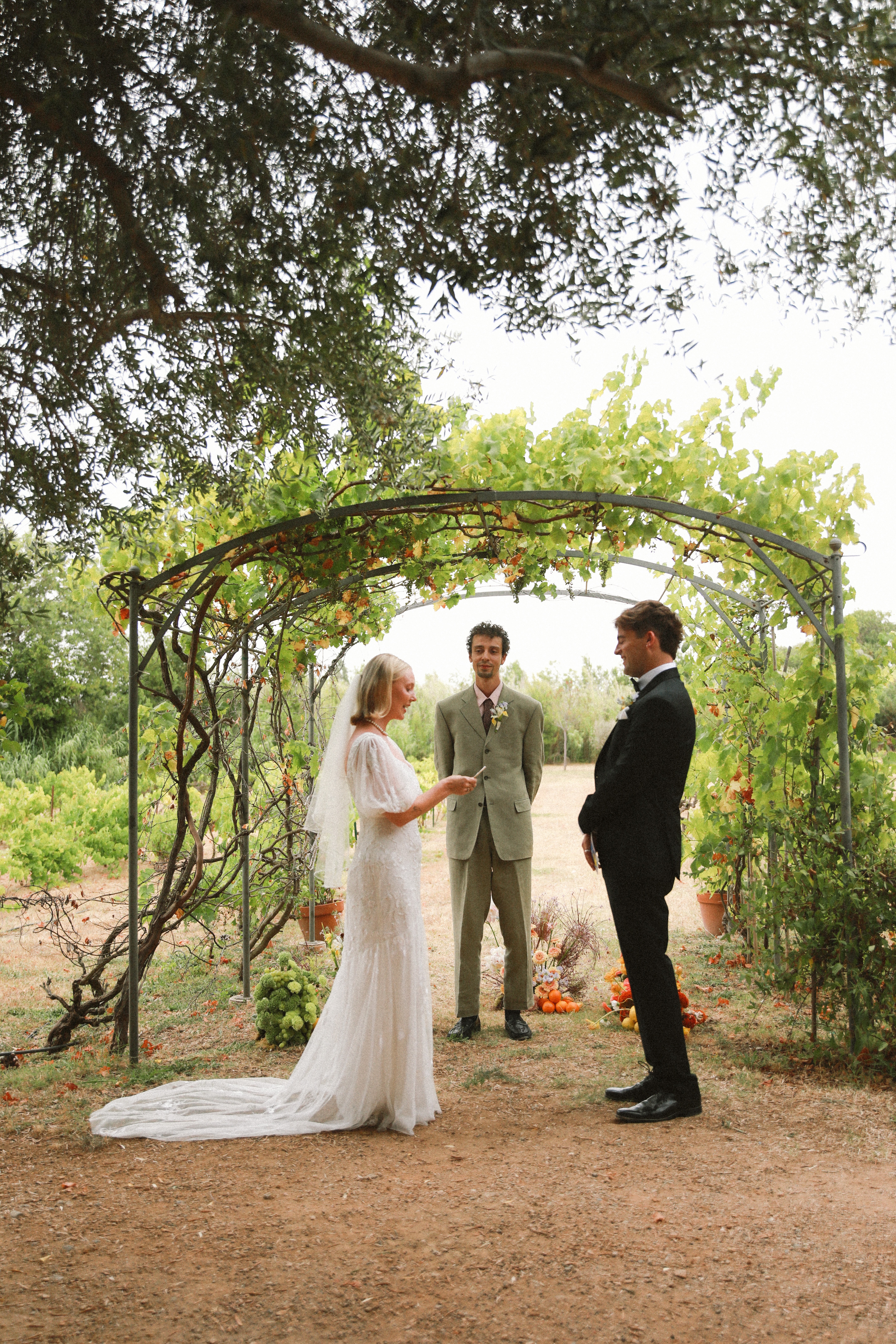 Bride reading vows at vineyard ceremony at Chateau du Puits es Pratx, Ginestas
