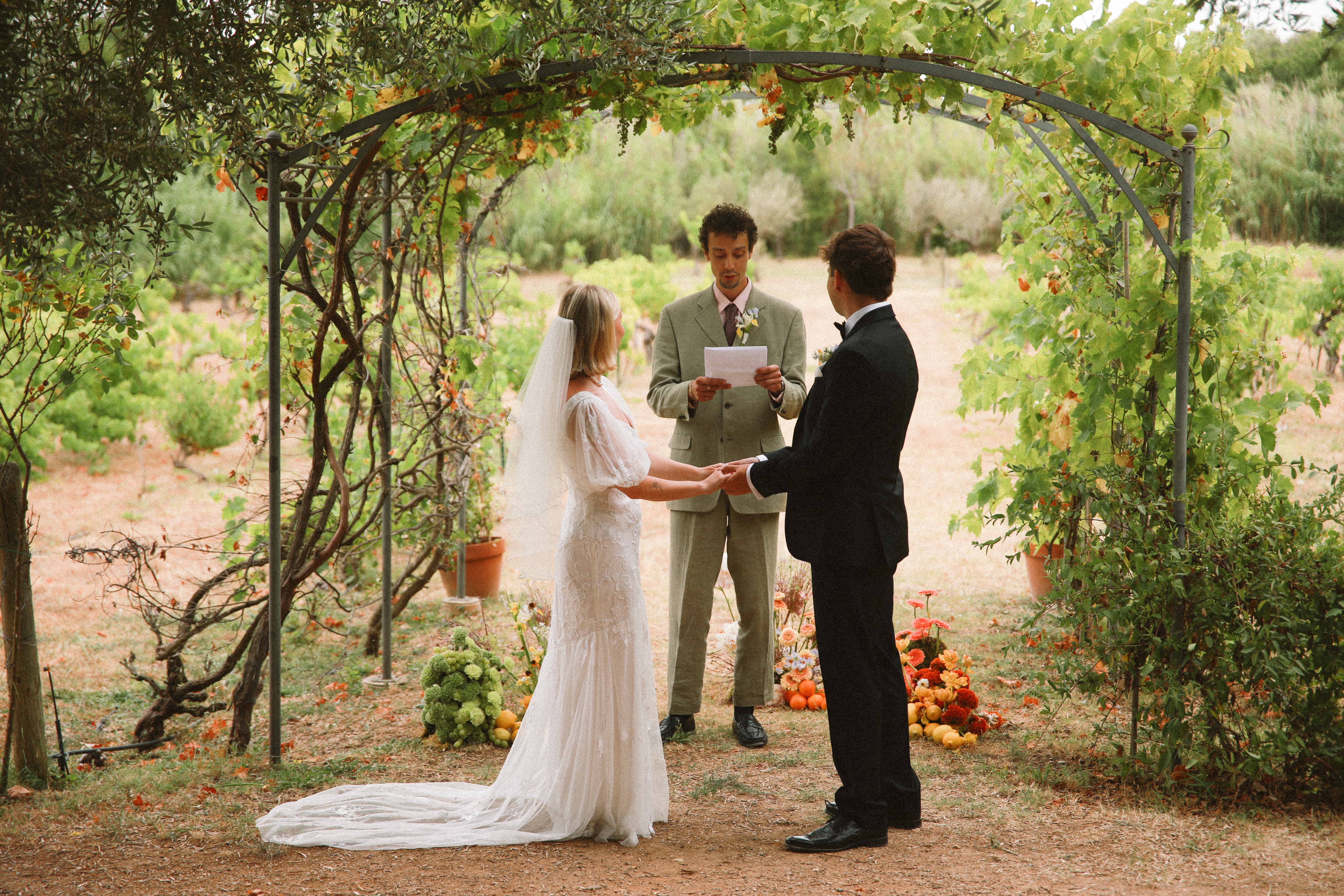 Ring exchange under vineyard arch at Chateau du Puits es Pratx, Ginestas