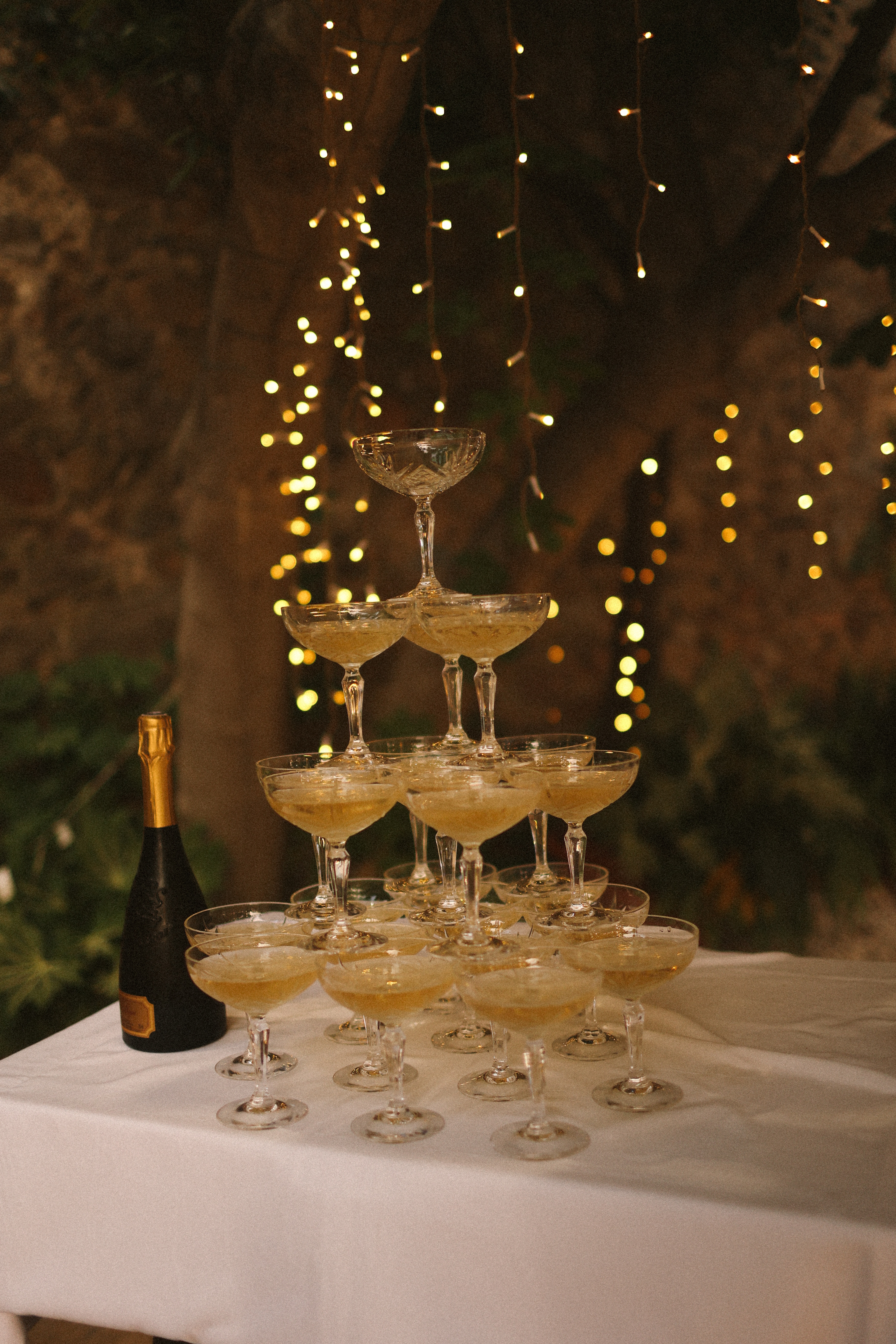 Champagne coupe tower with fairy lights at Chateau du Puits es Pratx, Ginestas