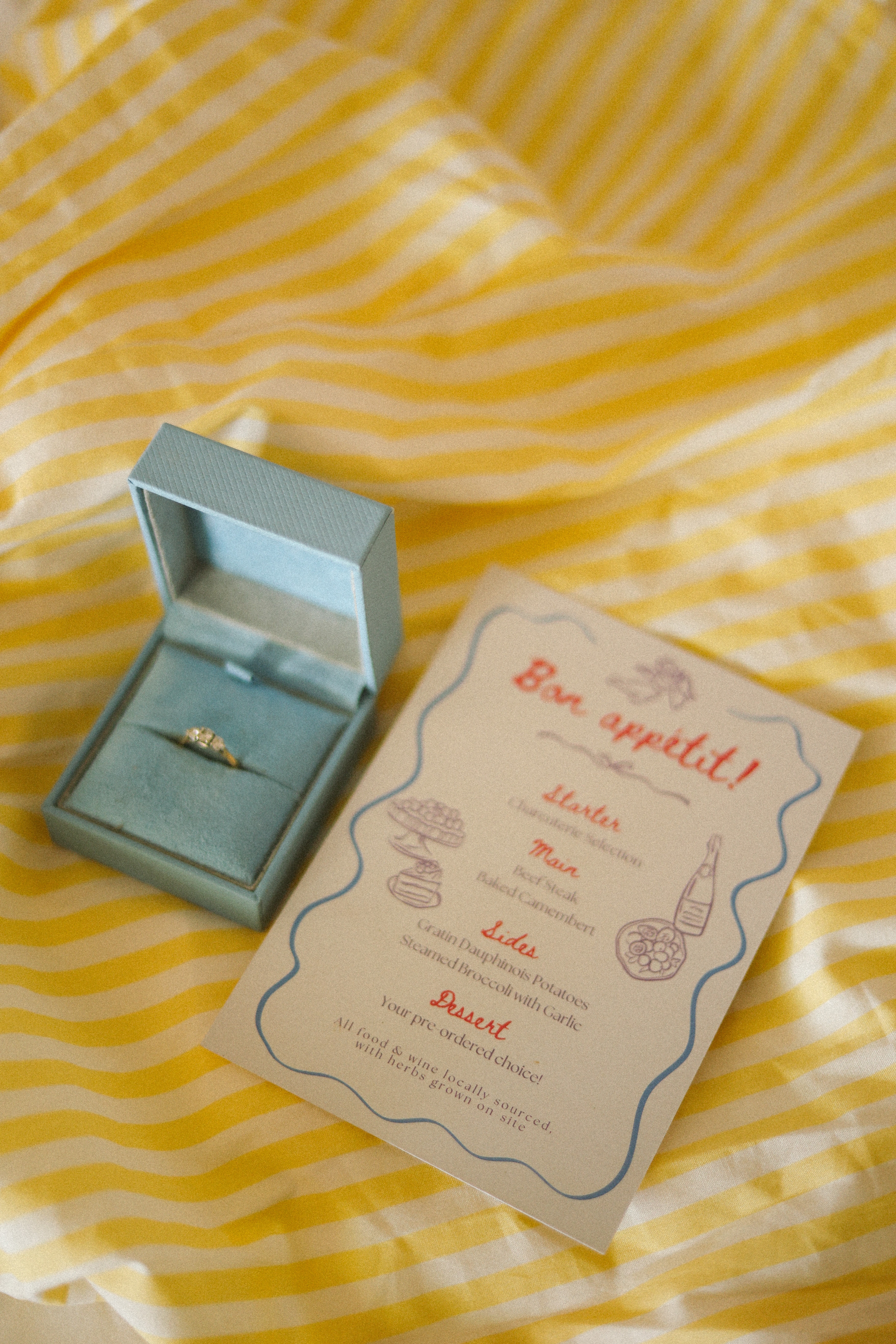 Menu card and ring box flat lay at Chateau du Puits es Pratx, Ginestas