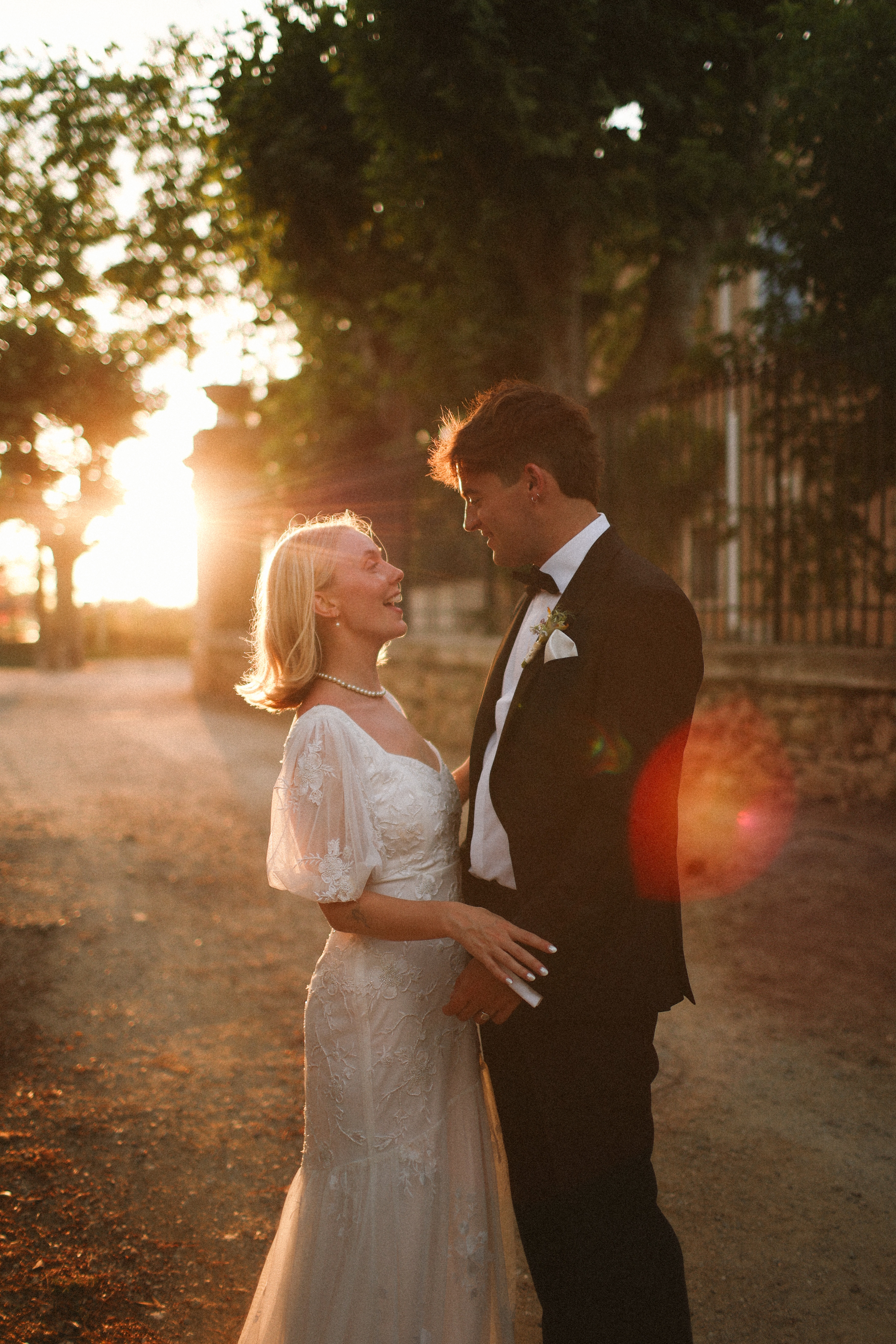 Couple laughing at golden hour on driveway at Chateau du Puits es Pratx, Ginestas