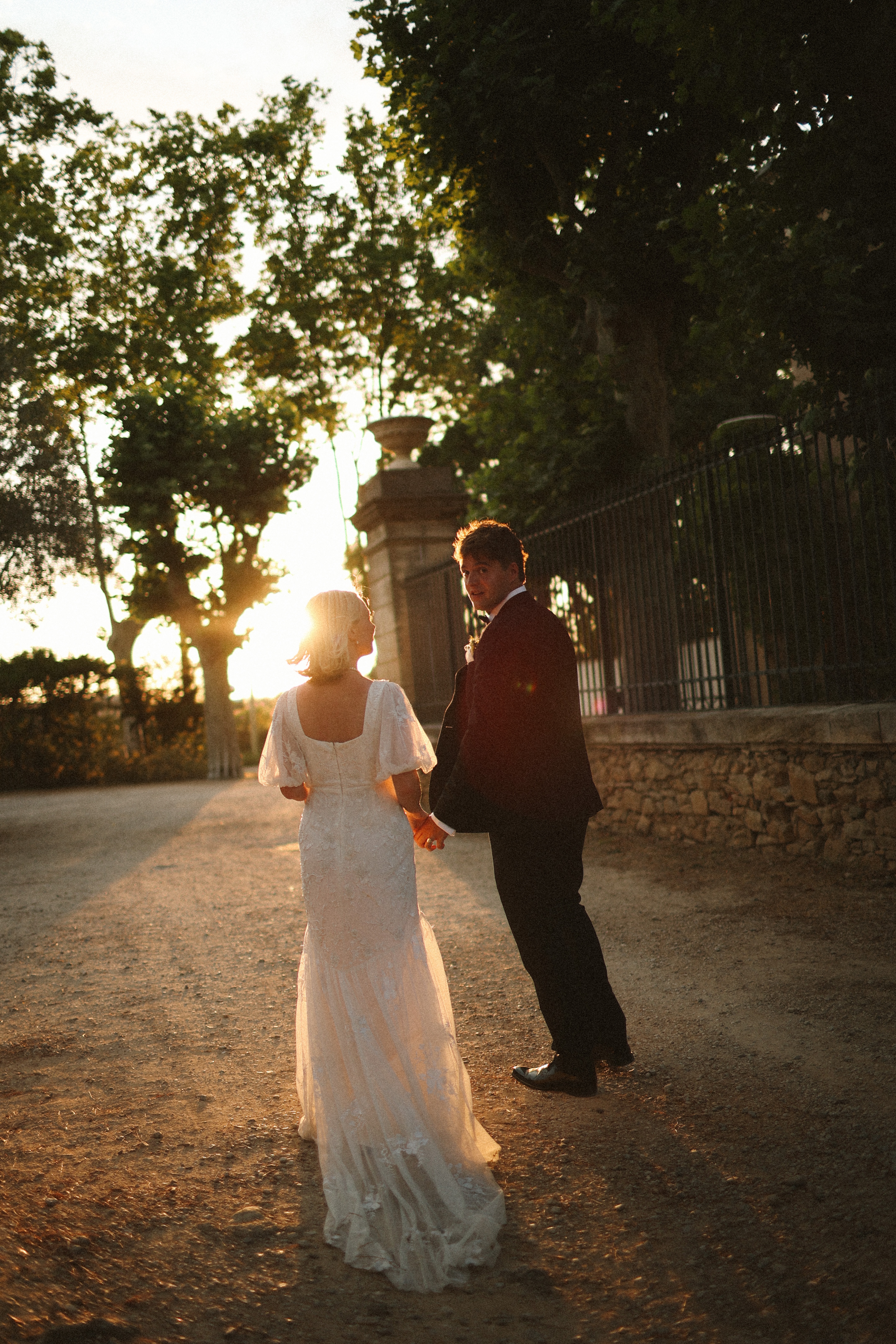 Couple walking hand in hand at sunset at Chateau du Puits es Pratx, Ginestas