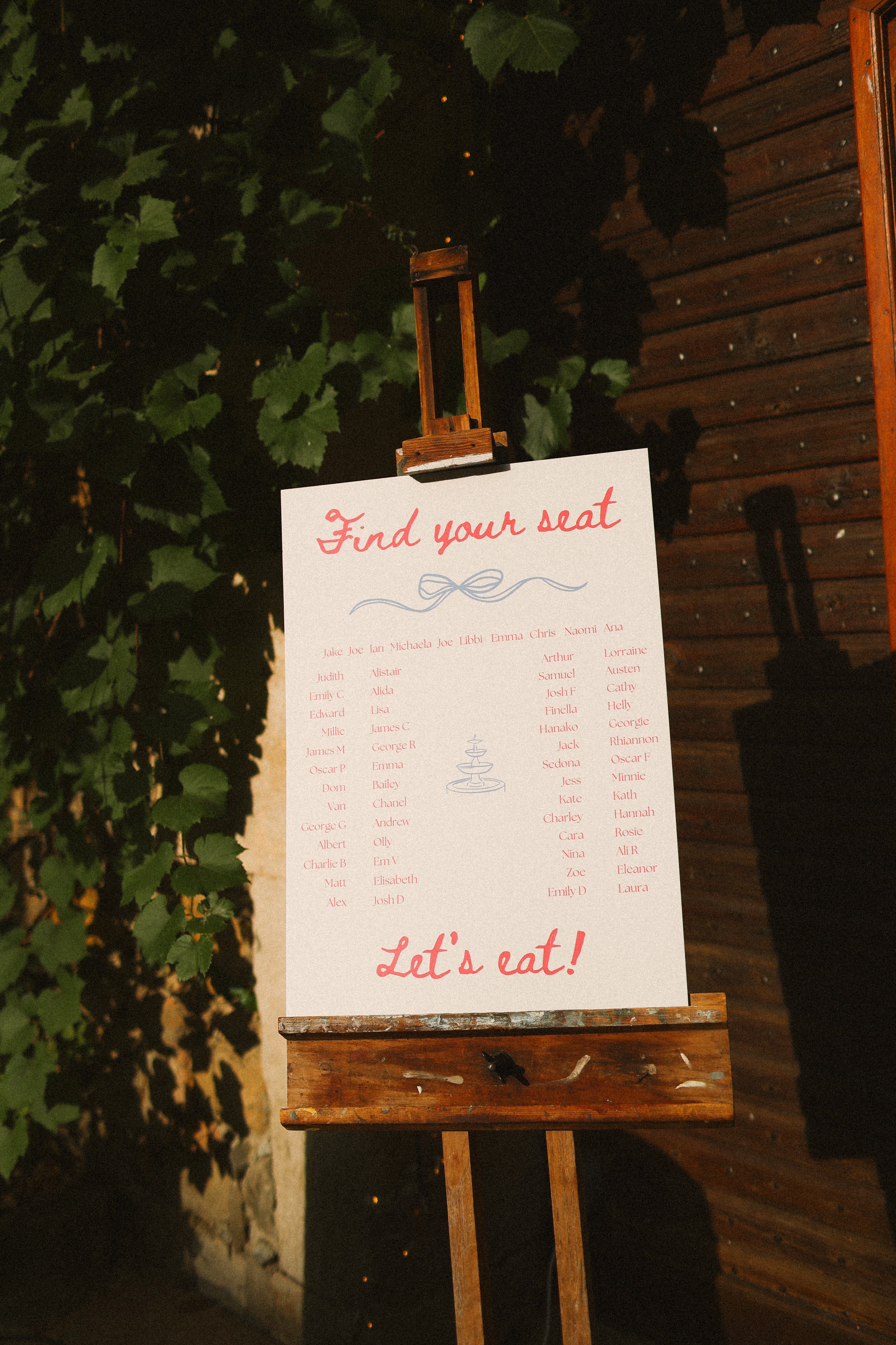 Hand lettered seating chart on easel at Chateau du Puits es Pratx, Ginestas