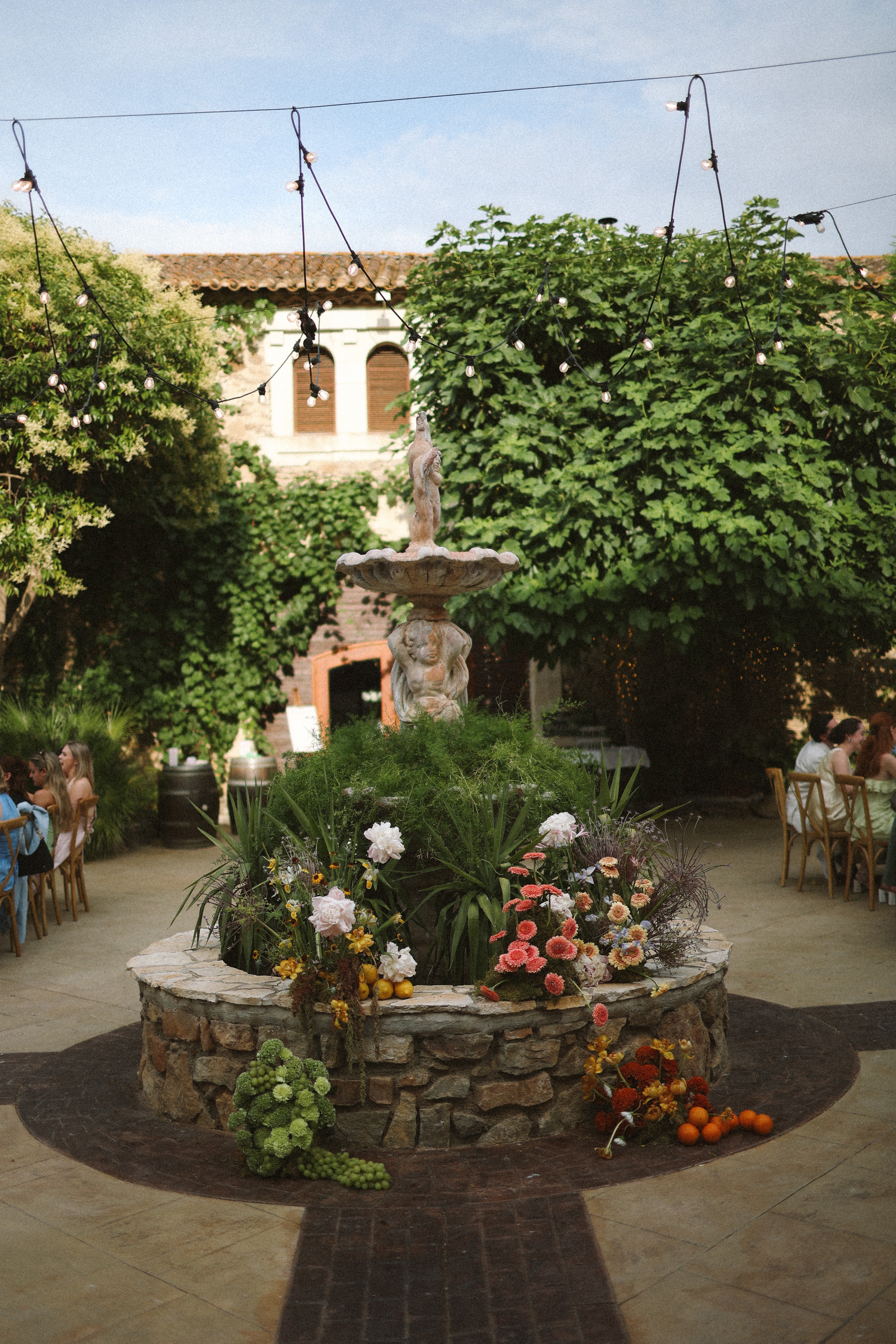 Courtyard fountain with floral base at Chateau du Puits es Pratx, Ginestas