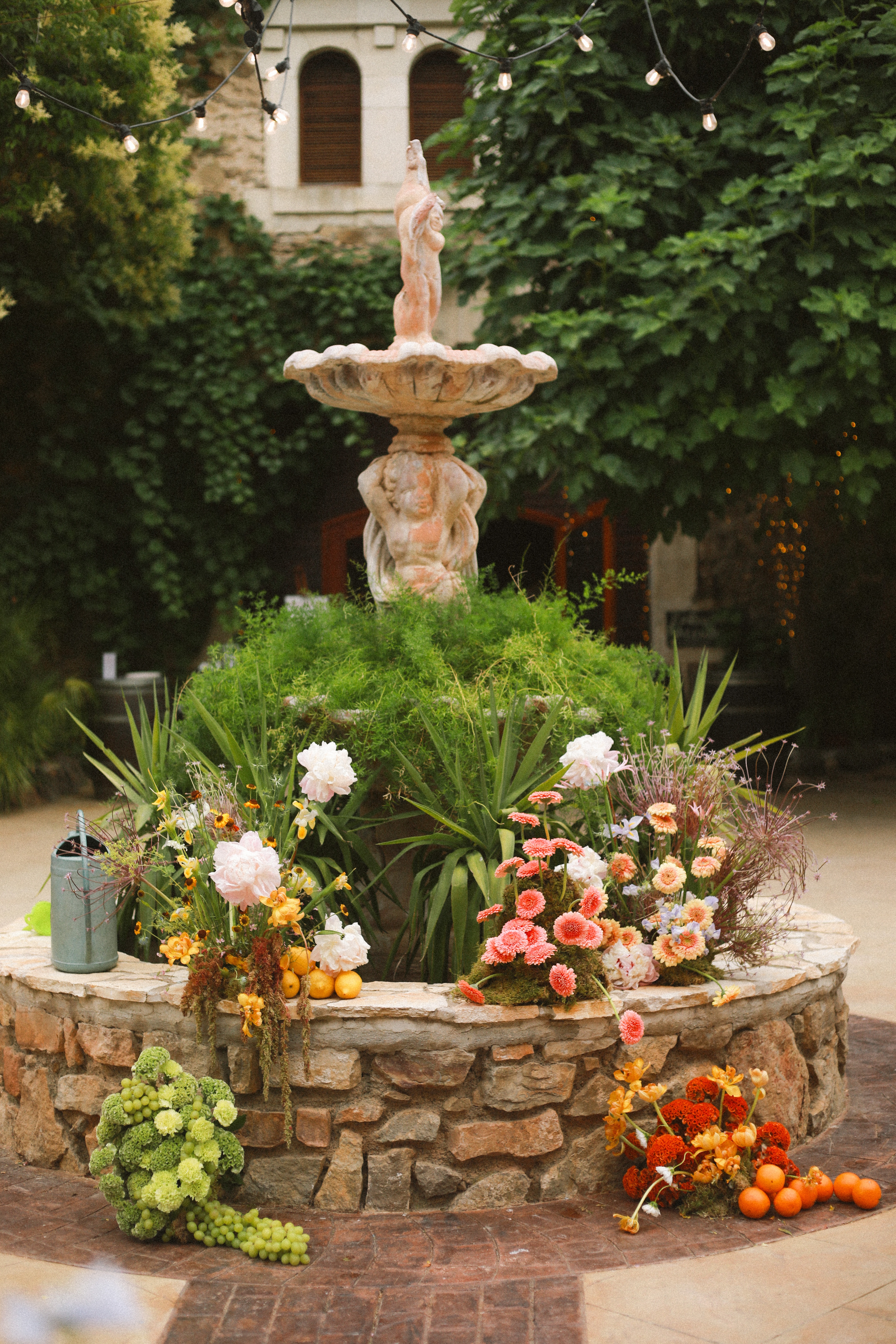 Tiered stone fountain with floral pillars at Chateau du Puits es Pratx, Ginestas