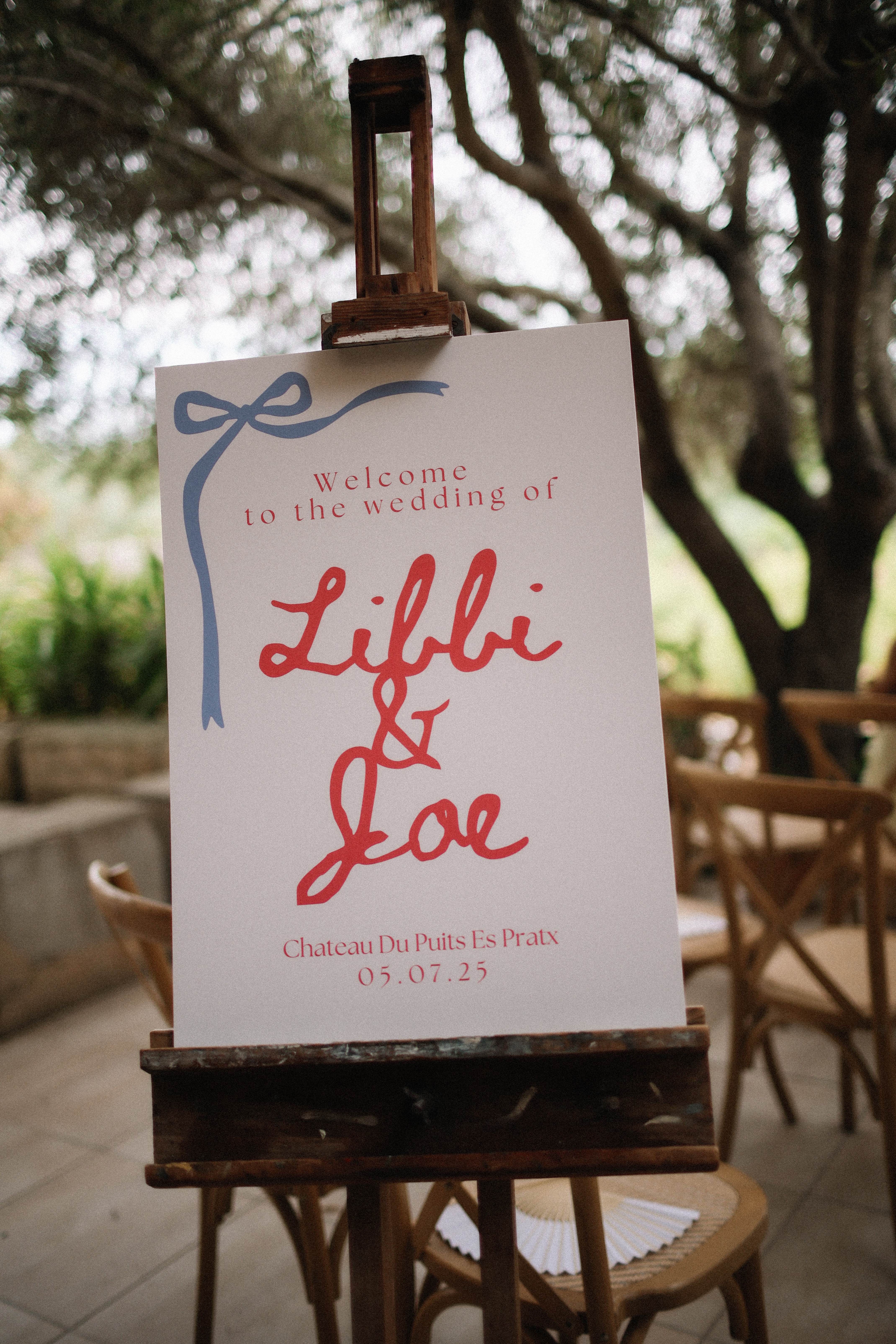 Hand lettered welcome sign on wooden easel at Chateau du Puits es Pratx, Ginestas