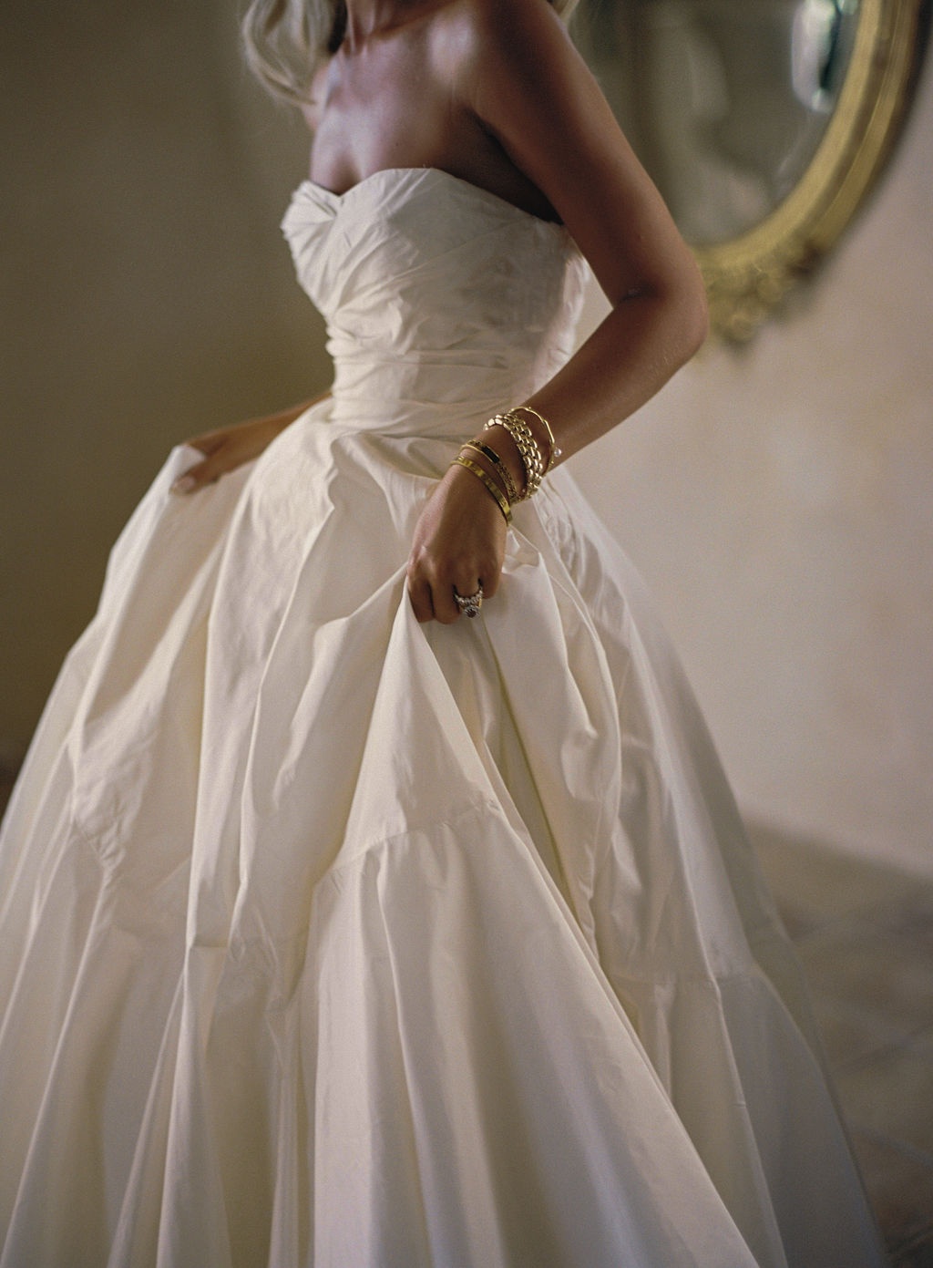bride in Dior reception gown with gold bangles at La Bastide de Laurence, Provence