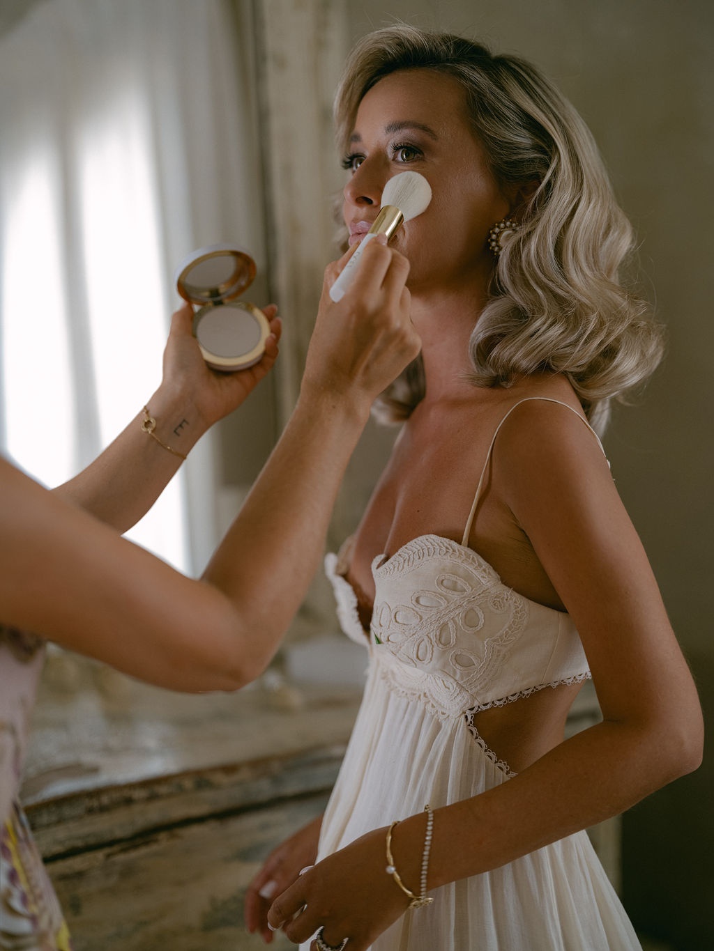 bride receiving final powder application at La Bastide de Laurence, Provence