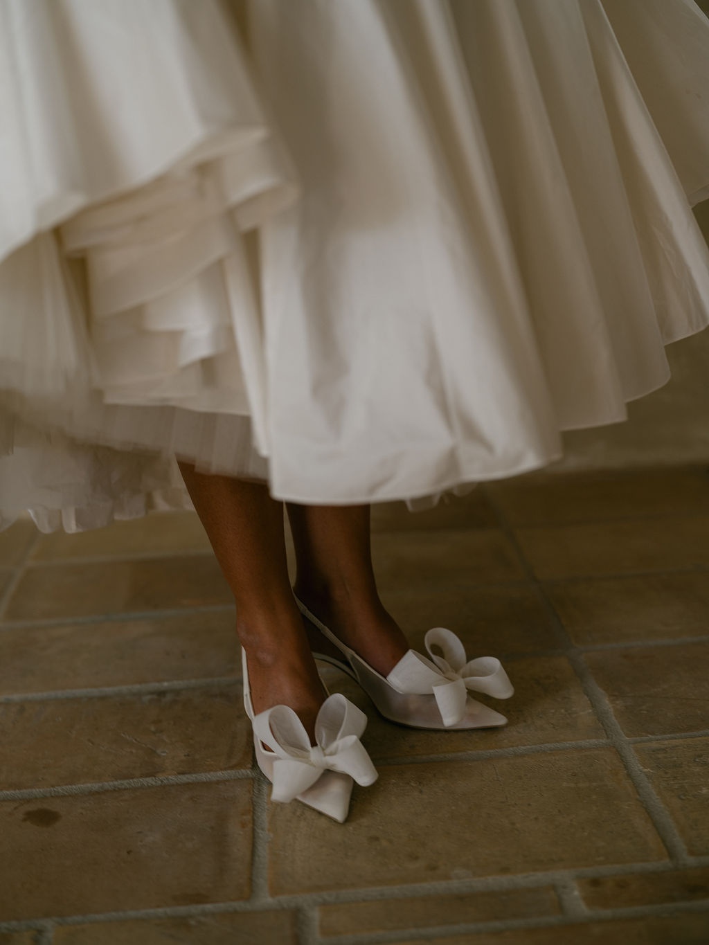 bride's satin bow heels beneath the Dior skirt at La Bastide de Laurence, Provence