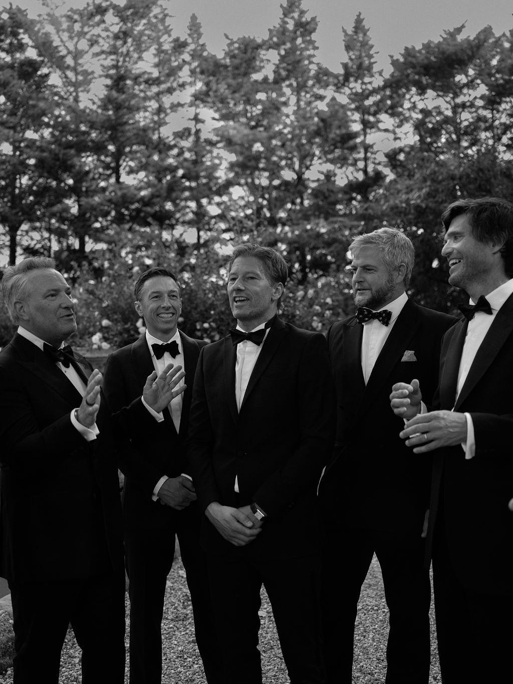 groom and groomsmen portrait by the stone wall at La Bastide de Laurence, Provence