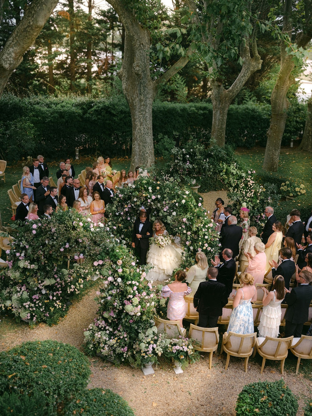couple exchanging vows beneath the floral arches at La Bastide de Laurence, Provence