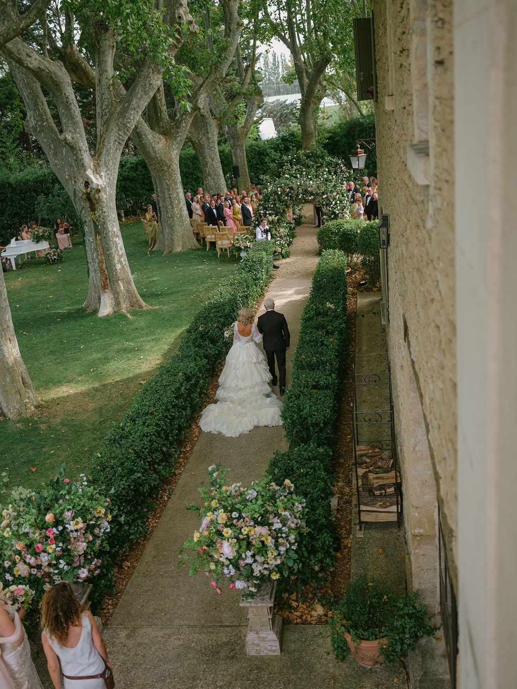 bride walking down the boxwood aisle with her father at La Bastide de Laurence, Provence