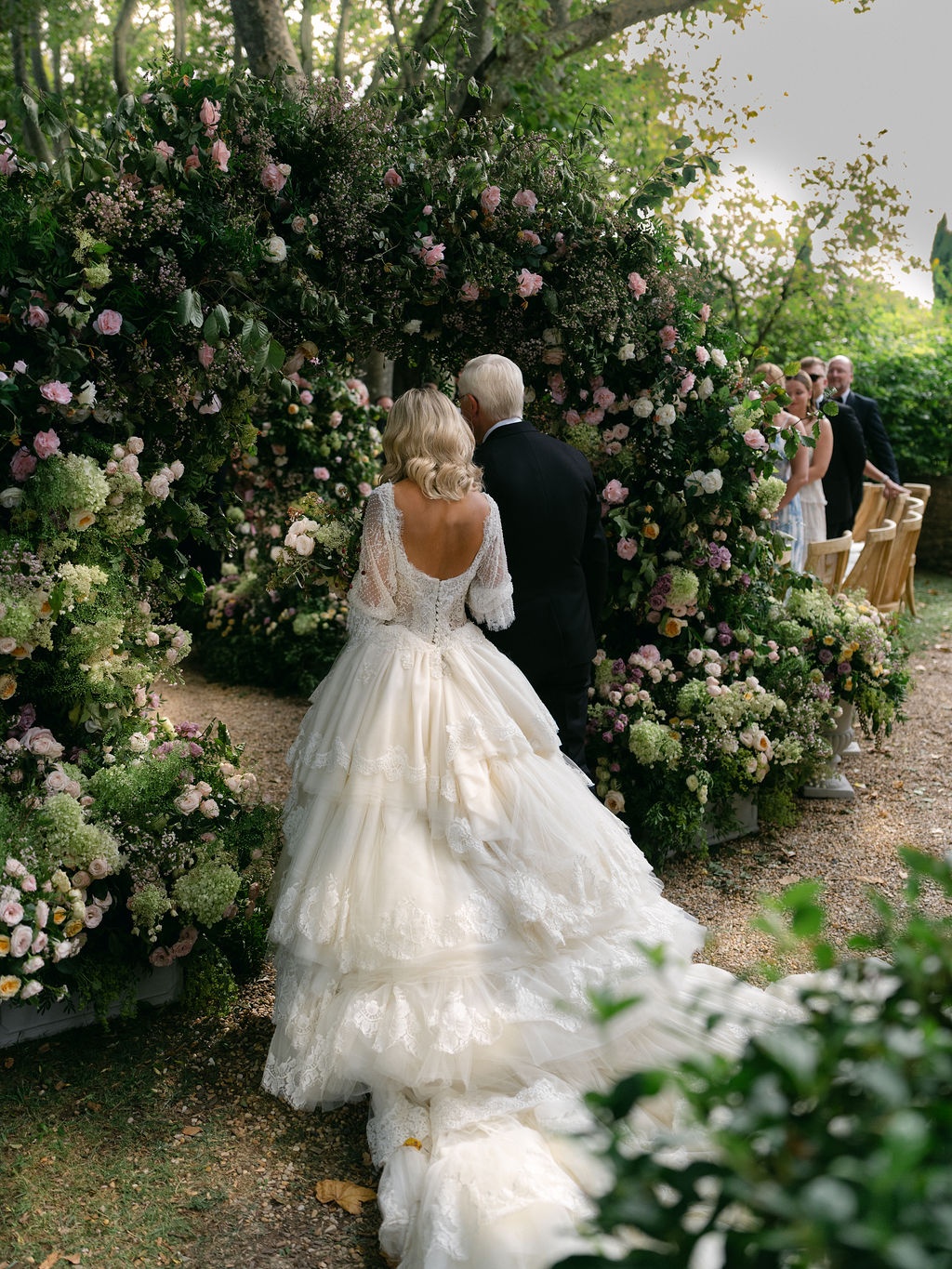 couple at the altar beneath the floral arches at La Bastide de Laurence, Provence