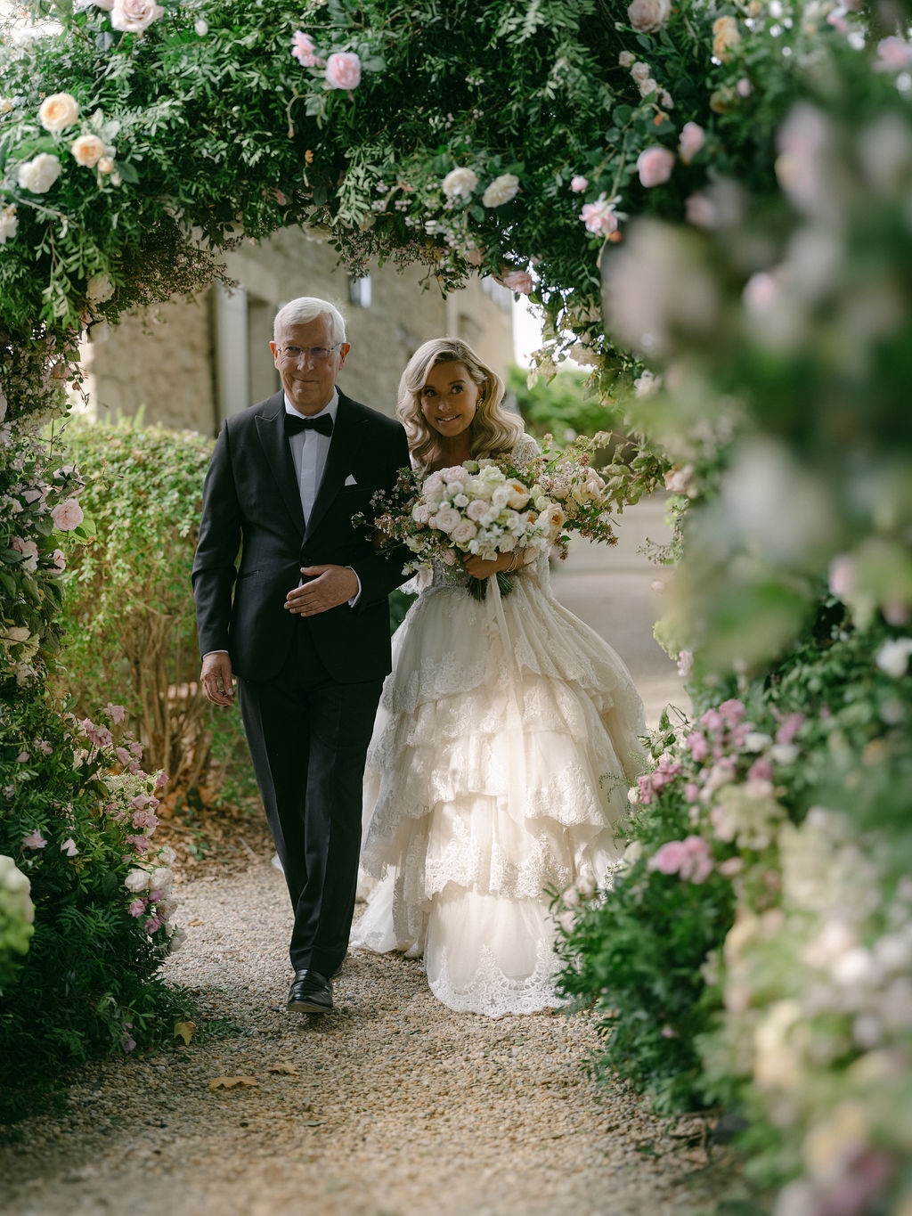 couple meeting at the arches as the ceremony begins at La Bastide de Laurence, Provence