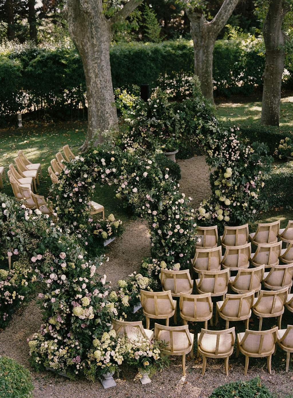 ceremony aisle set with cane chairs on the lawn at La Bastide de Laurence, Provence