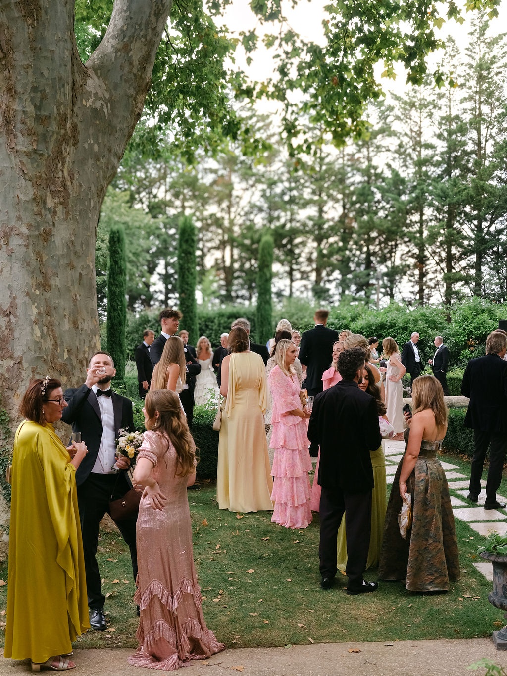 guests gathered under a plane tree for drinks at La Bastide de Laurence, Provence