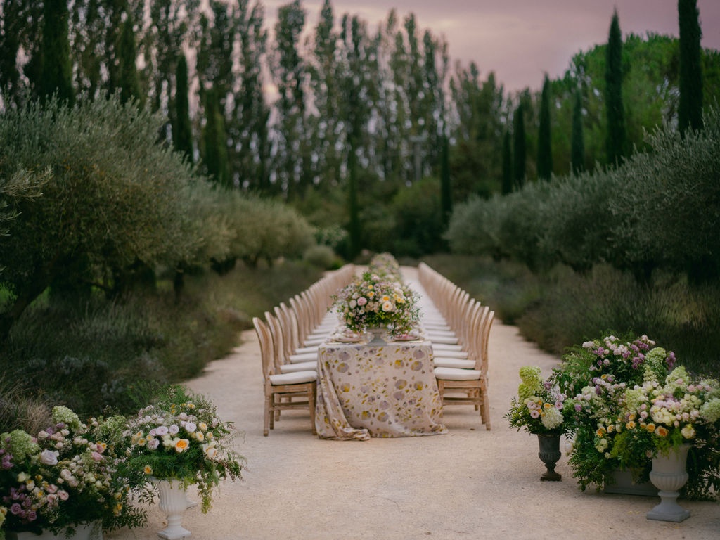 full dinner table viewed down the allee at dusk at La Bastide de Laurence, Provence