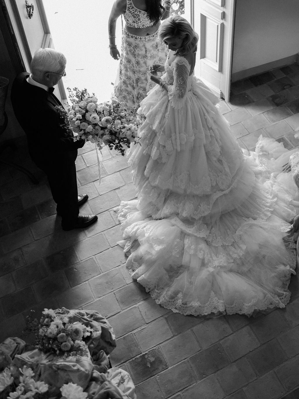bride descending the staircase with her father waiting at La Bastide de Laurence, Provence