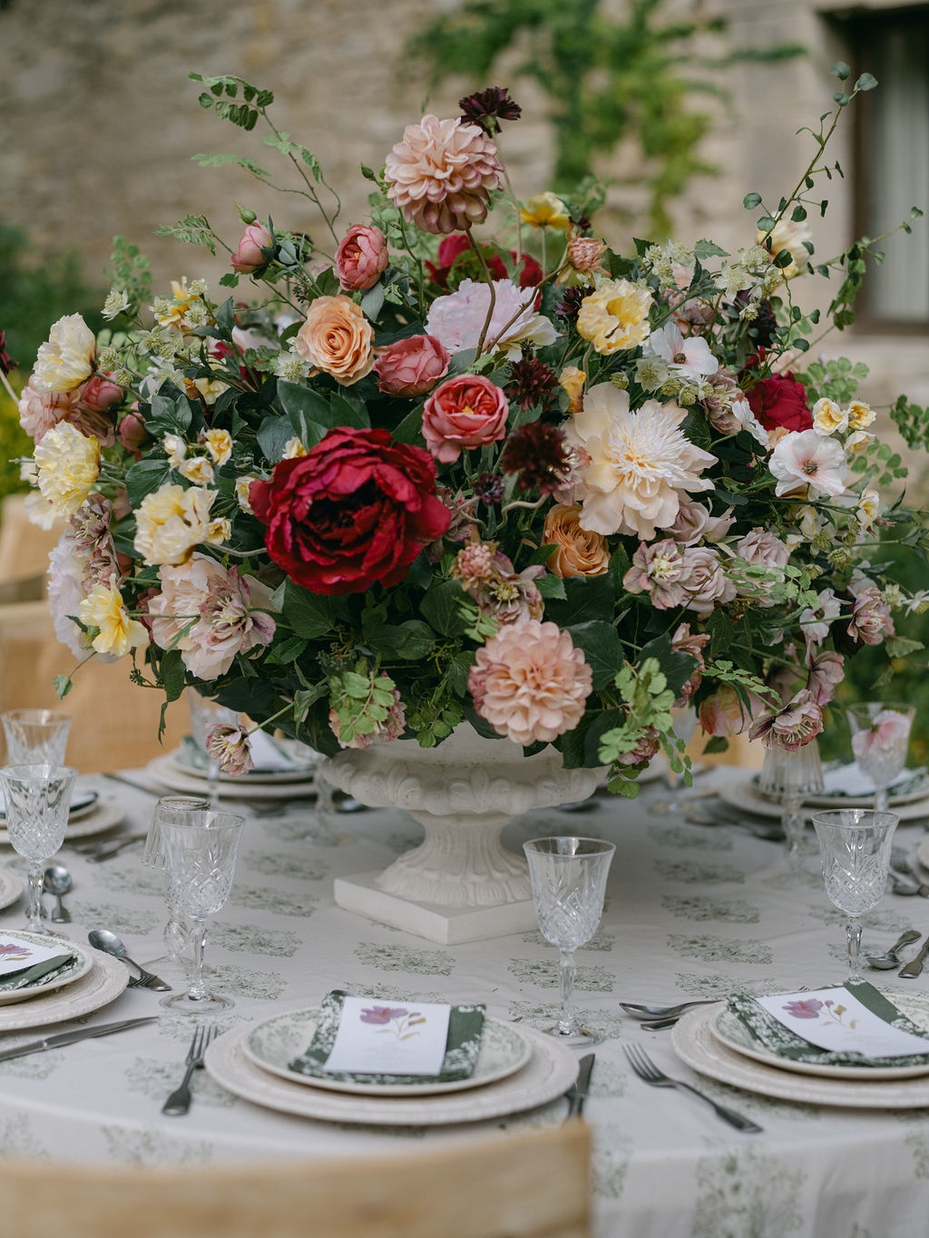 low arrangement of dahlias and roses in the courtyard at La Bastide de Laurence, Provence