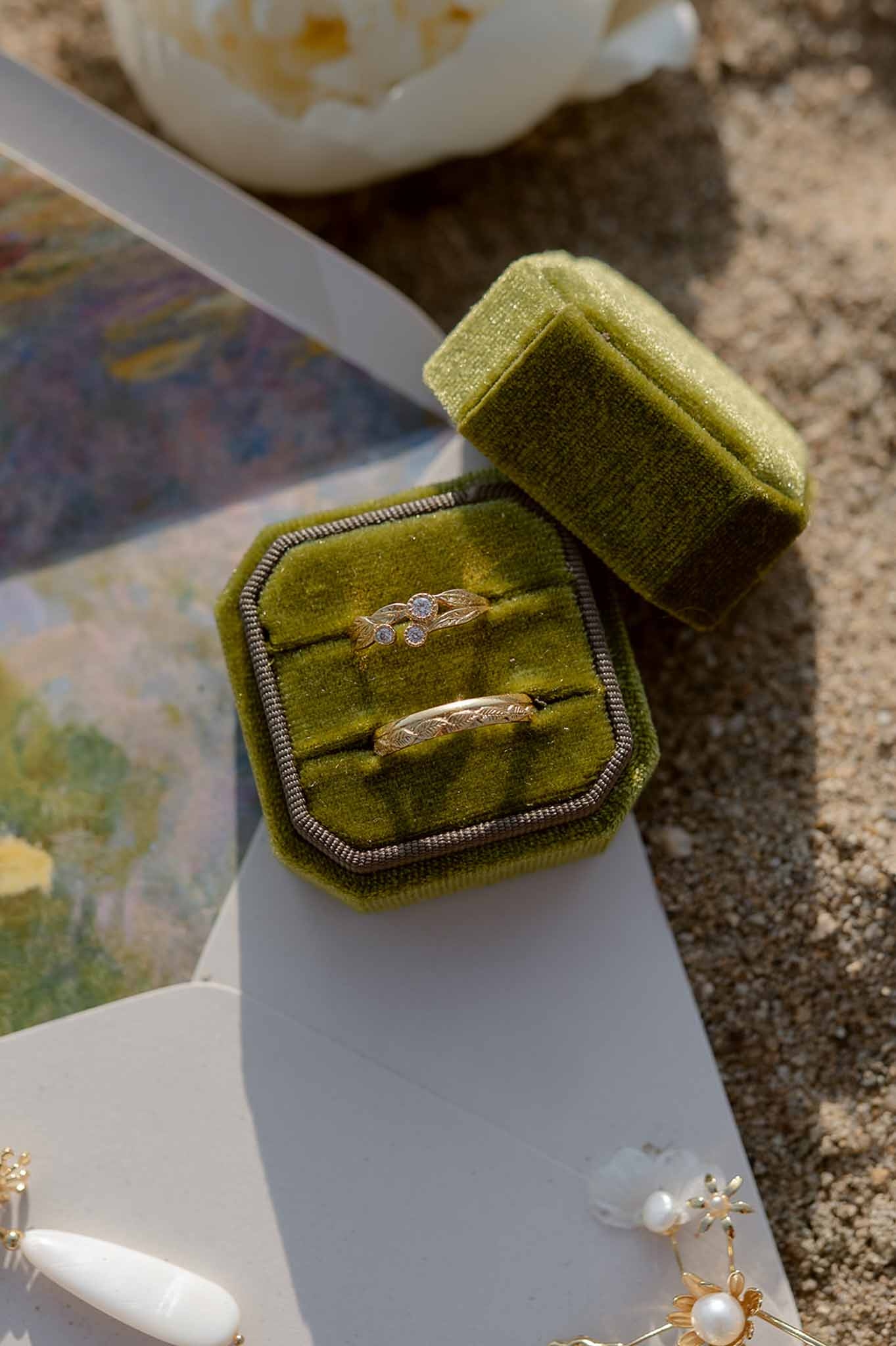 Wedding rings in green velvet box with Monet stationery at Plage d'Apremont-sur-Allier