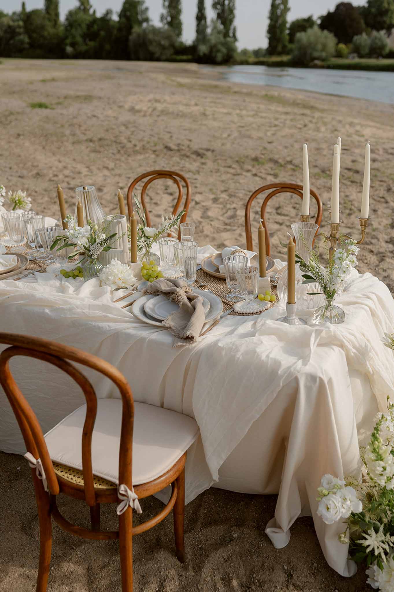 Lakeside tablescape with gold candelabras and wildflowers at Plage d'Apremont-sur-Allier