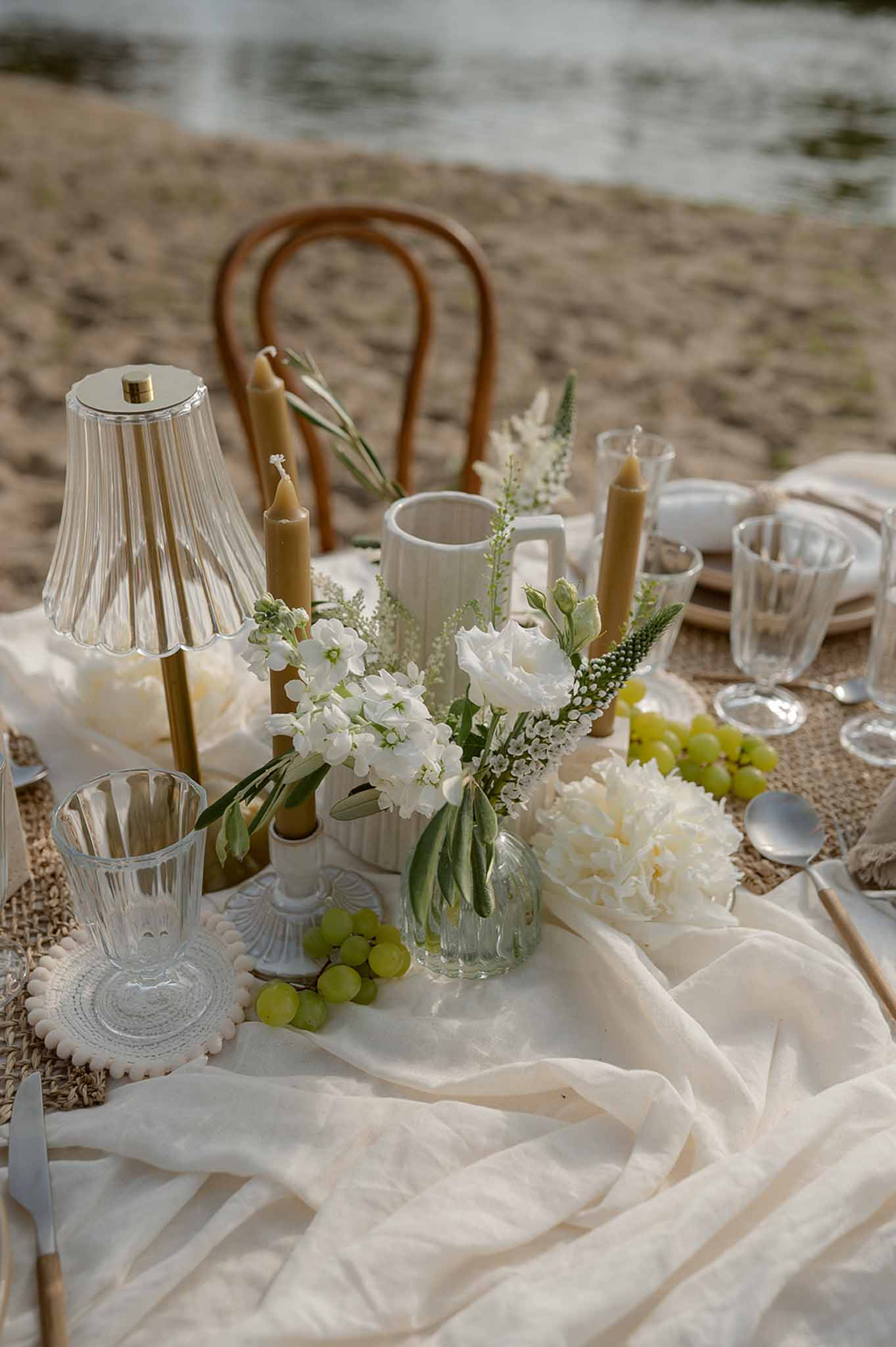 Table centrepiece with peonies and gold candles at Plage d'Apremont-sur-Allier