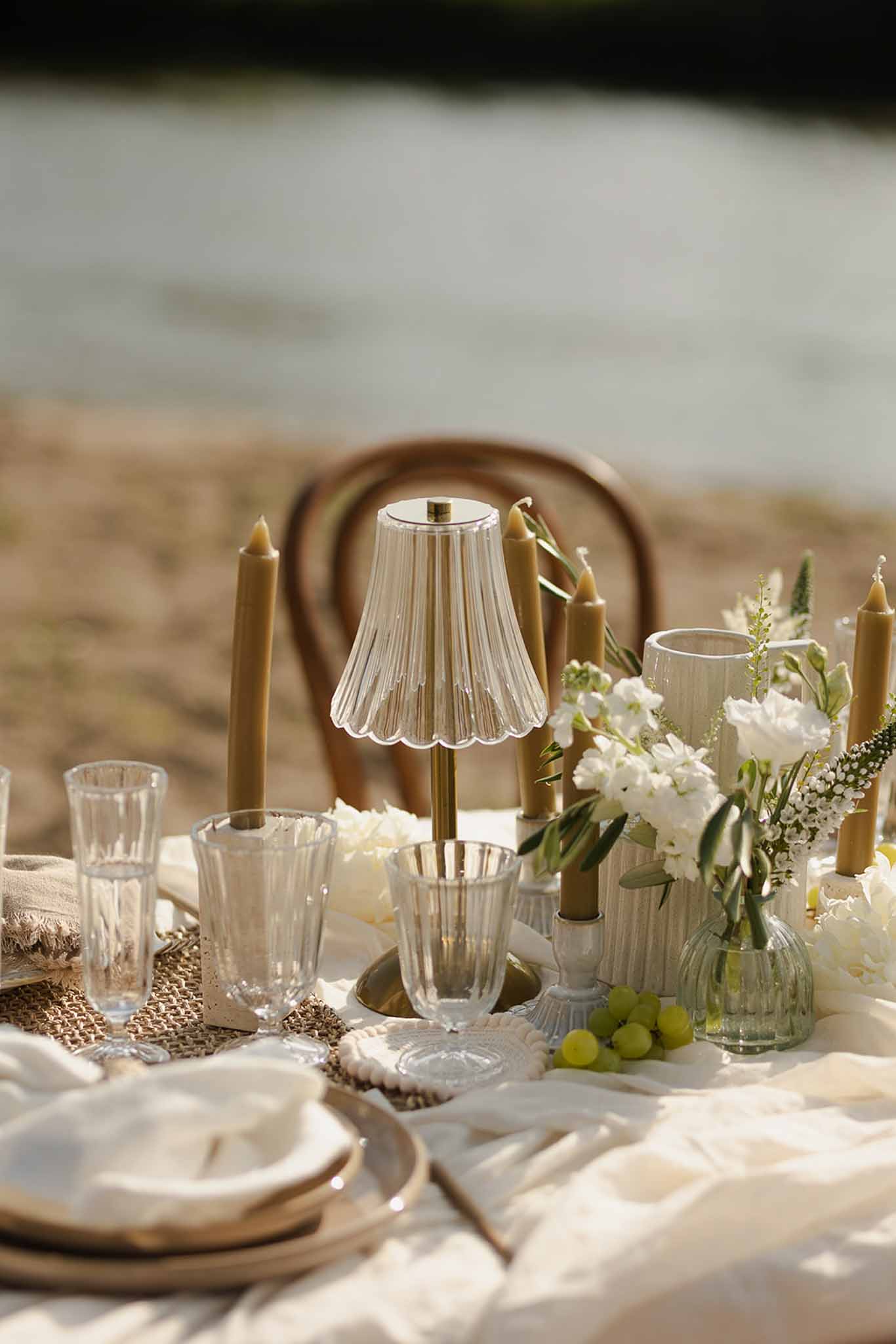 Glass lamp and gold candle table detail at Plage d'Apremont-sur-Allier wedding