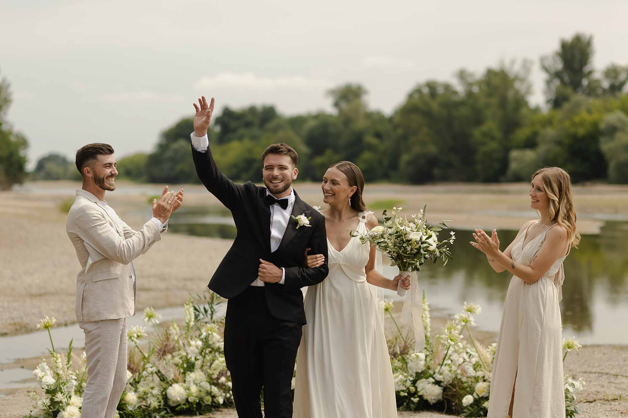 Couple celebrating after ceremony exit at Plage d'Apremont-sur-Allier Burgundy