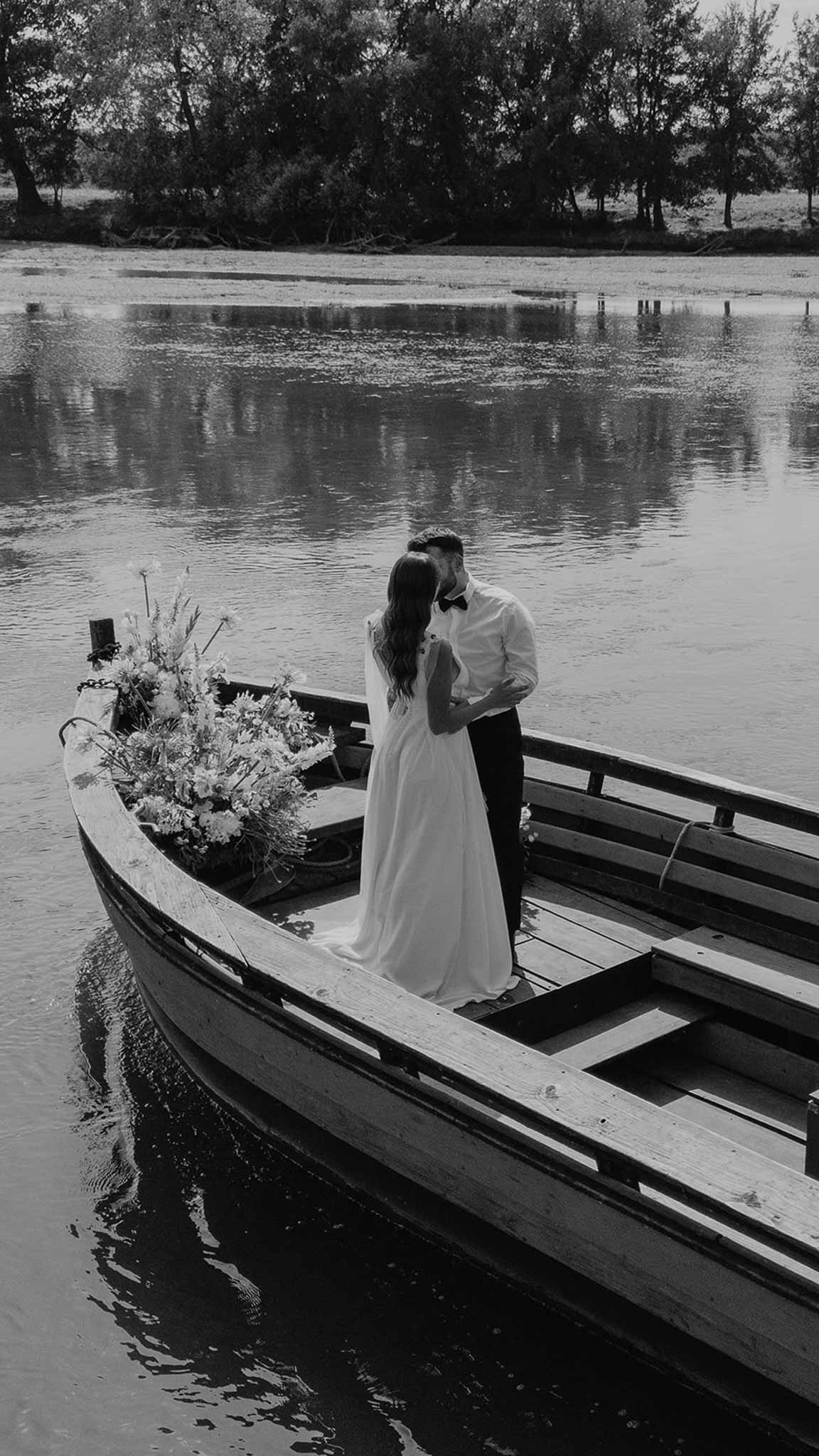 Couple kissing in flower-filled boat on river at Plage d'Apremont-sur-Allier