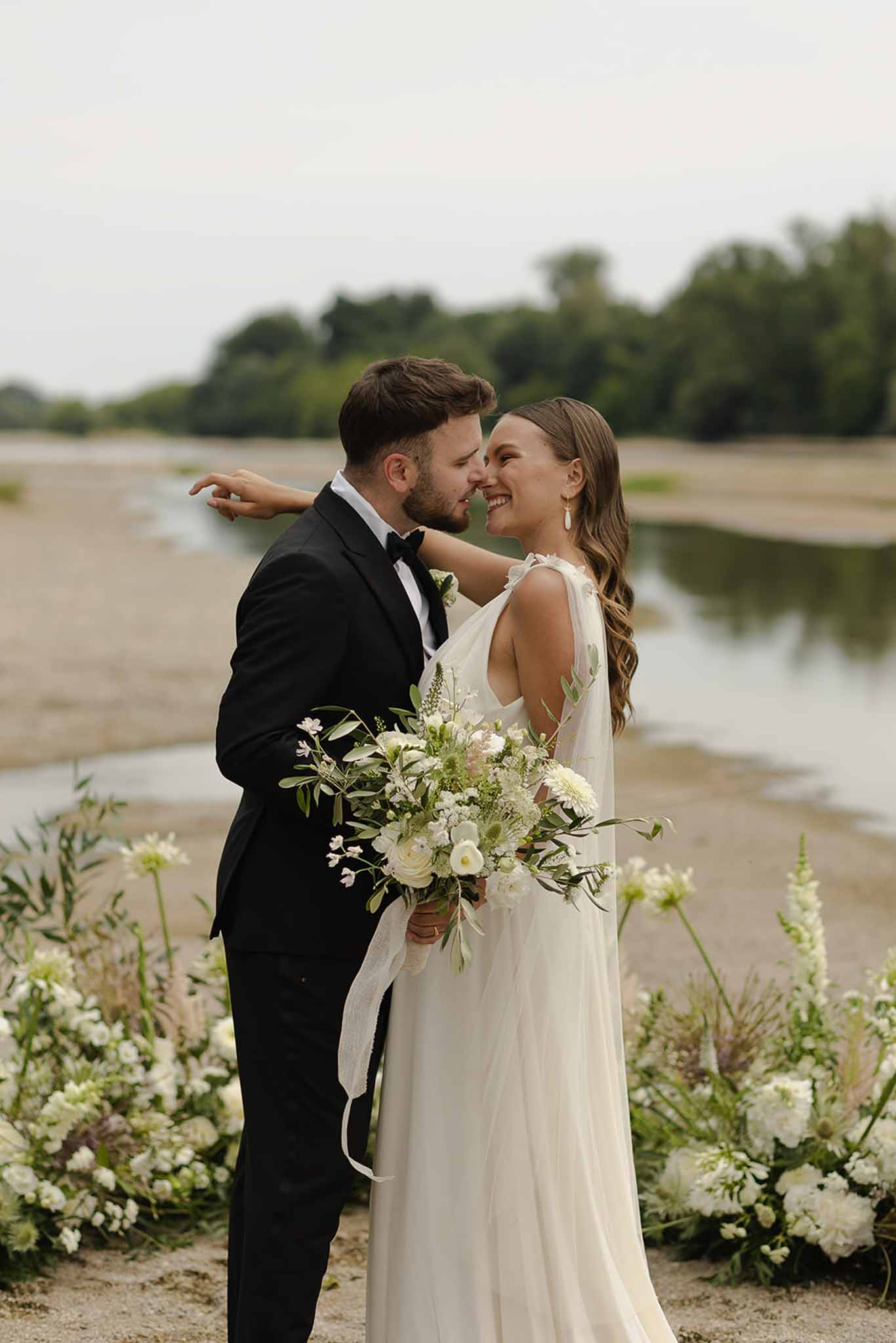 Couple portrait at ceremony arch at Plage d'Apremont-sur-Allier Burgundy