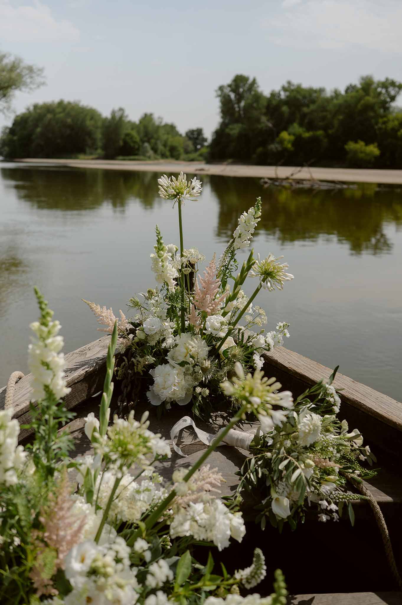 Wild white florals filling bow of boat on river at Plage d'Apremont-sur-Allier