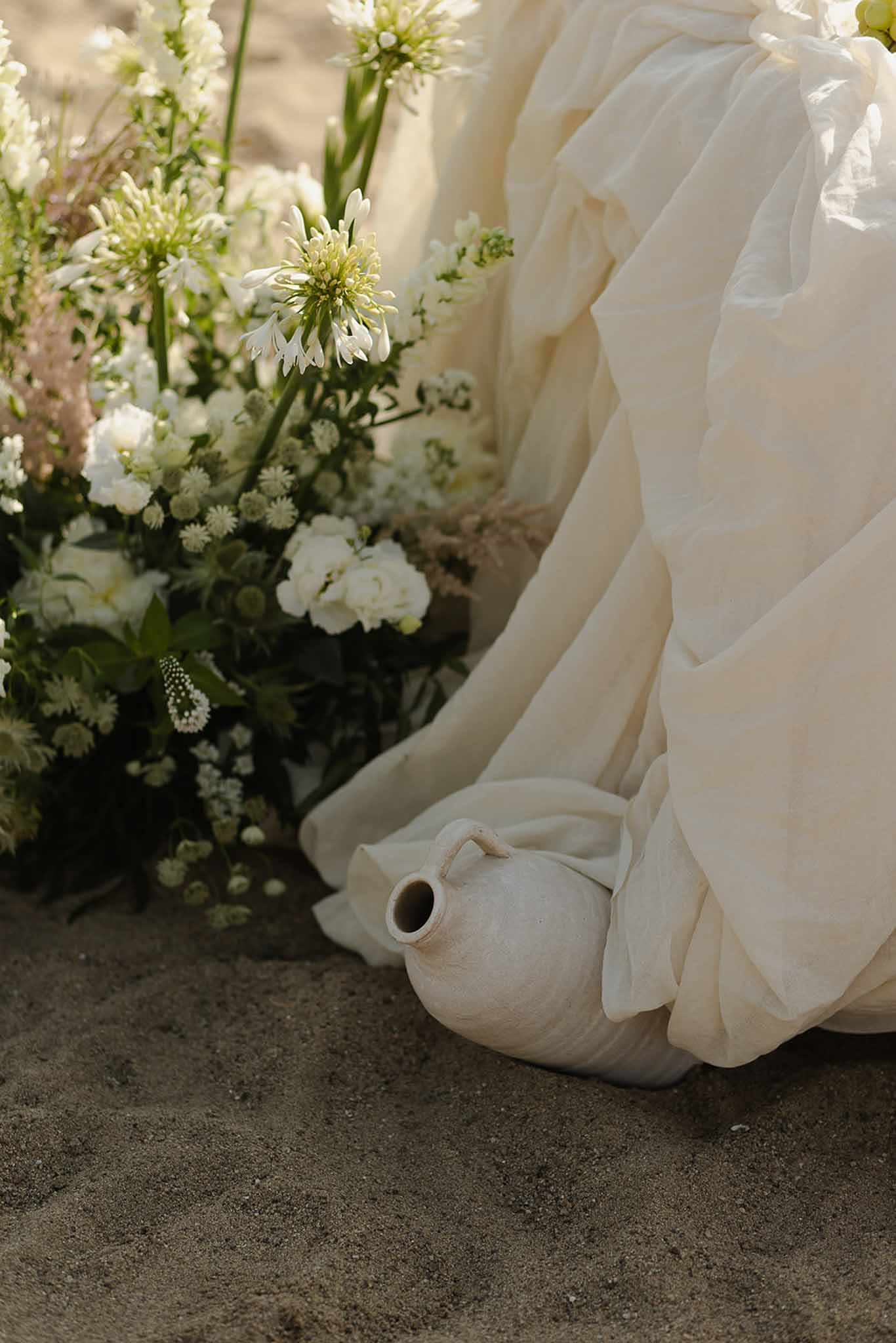 Ceramic vase and wildflowers on sand at Plage d'Apremont-sur-Allier reception