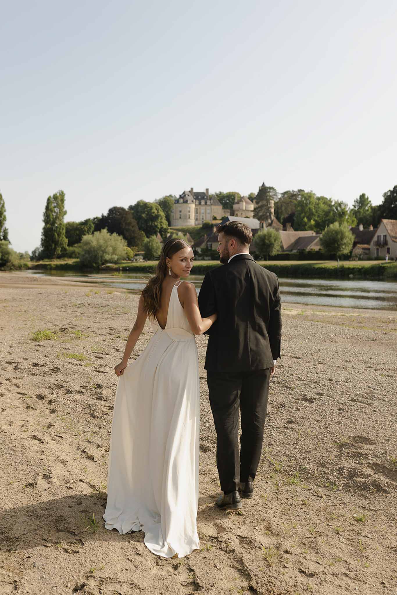Couple walking toward chateau at golden hour at Plage d'Apremont-sur-Allier