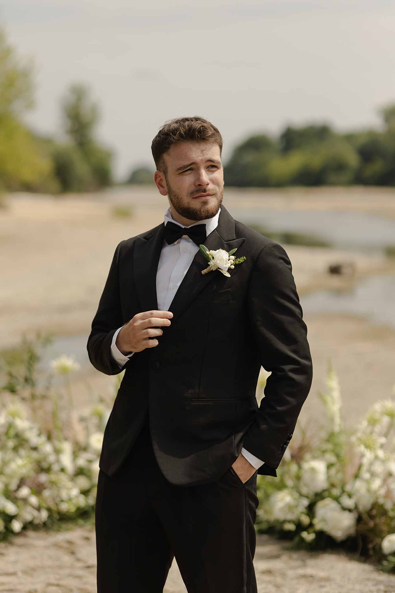 Groom portrait in black tuxedo at ceremony at Plage d'Apremont-sur-Allier