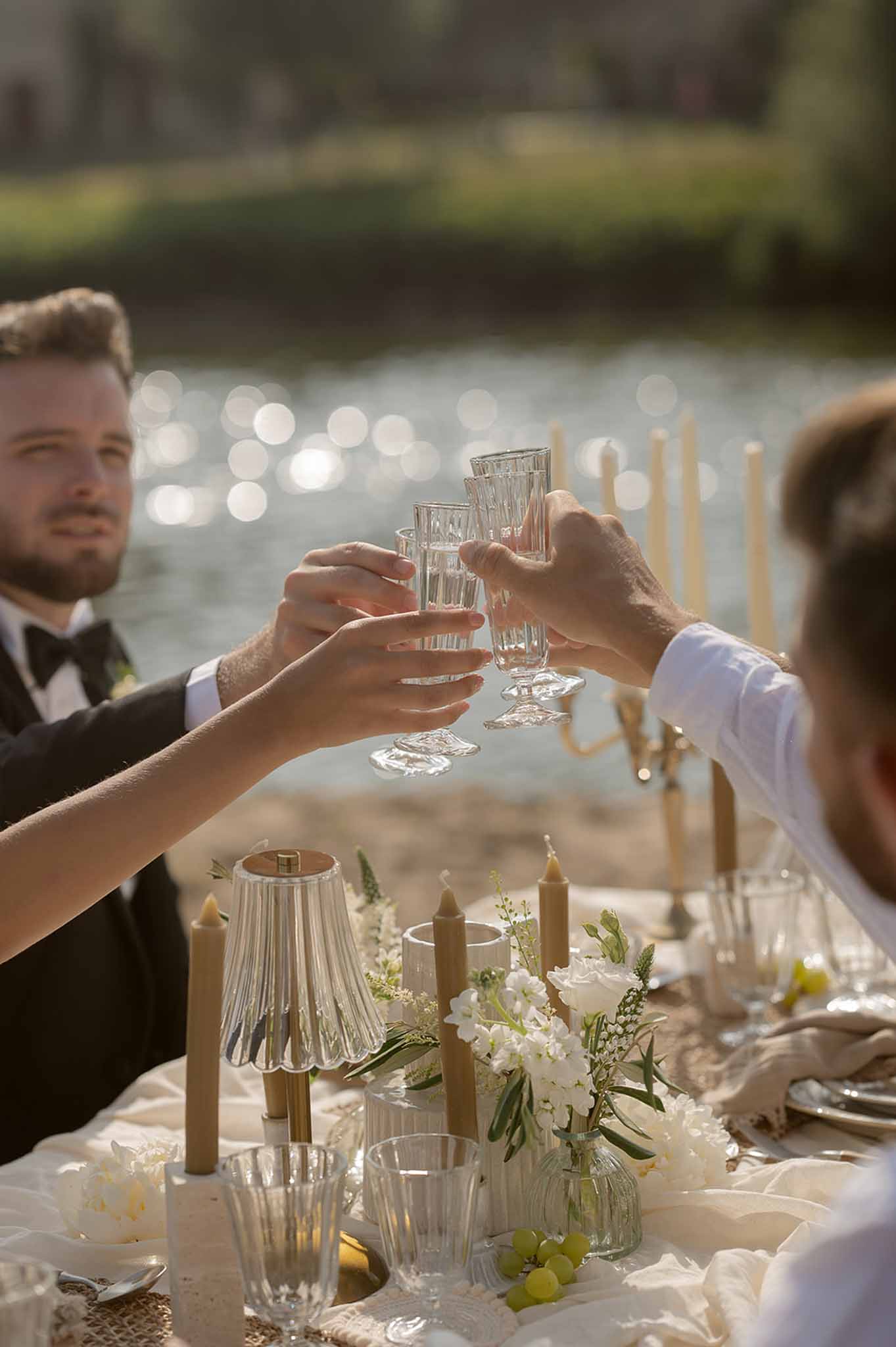Guests toasting at golden hour reception at Plage d'Apremont-sur-Allier